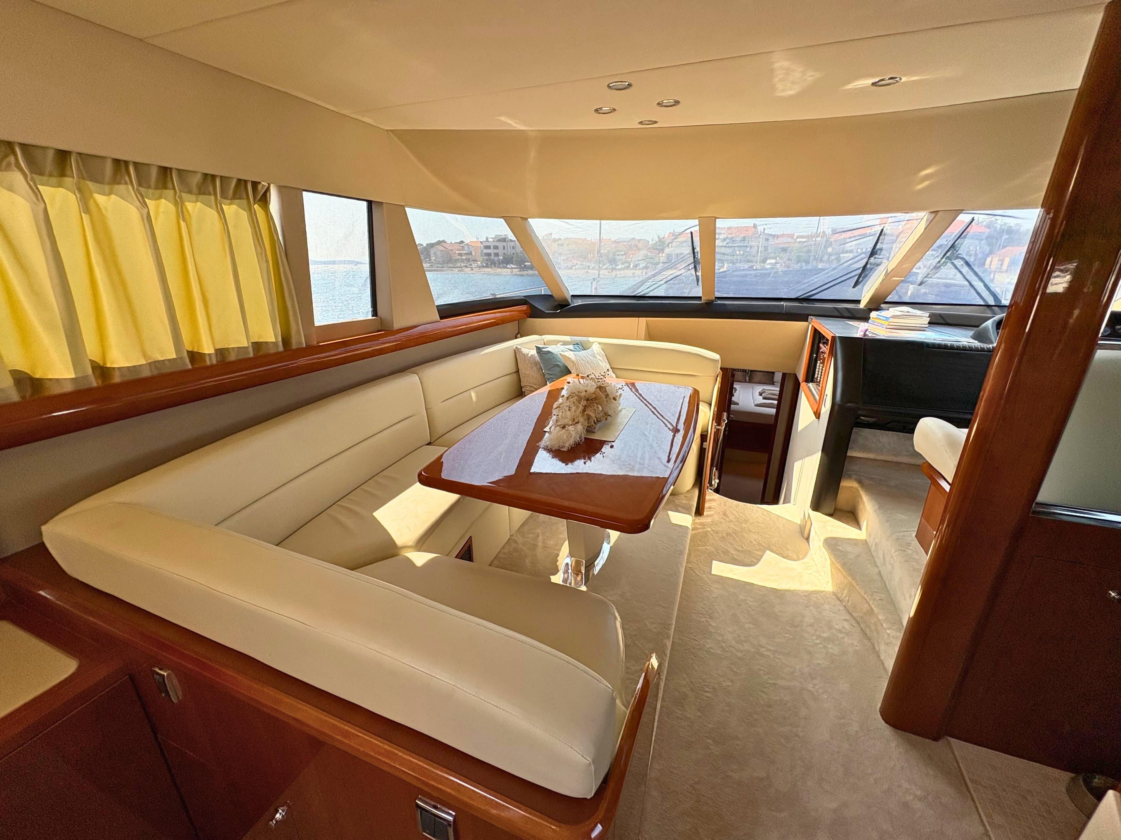 Luxurious interior of 2007 Princess 21M yacht with elegant seating and panoramic windows.