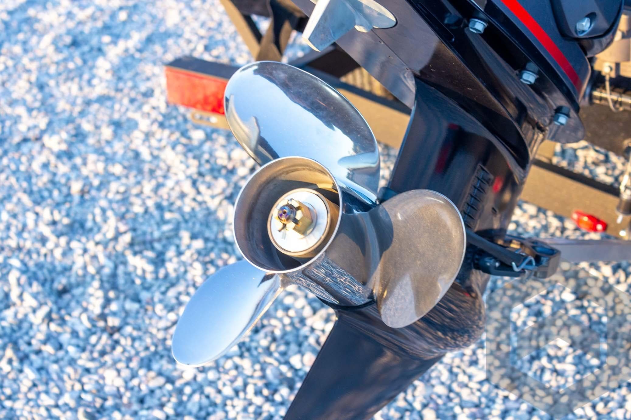 Close-up of a 2026 G3 Sportsman 1810 SE boat propeller on gravel.