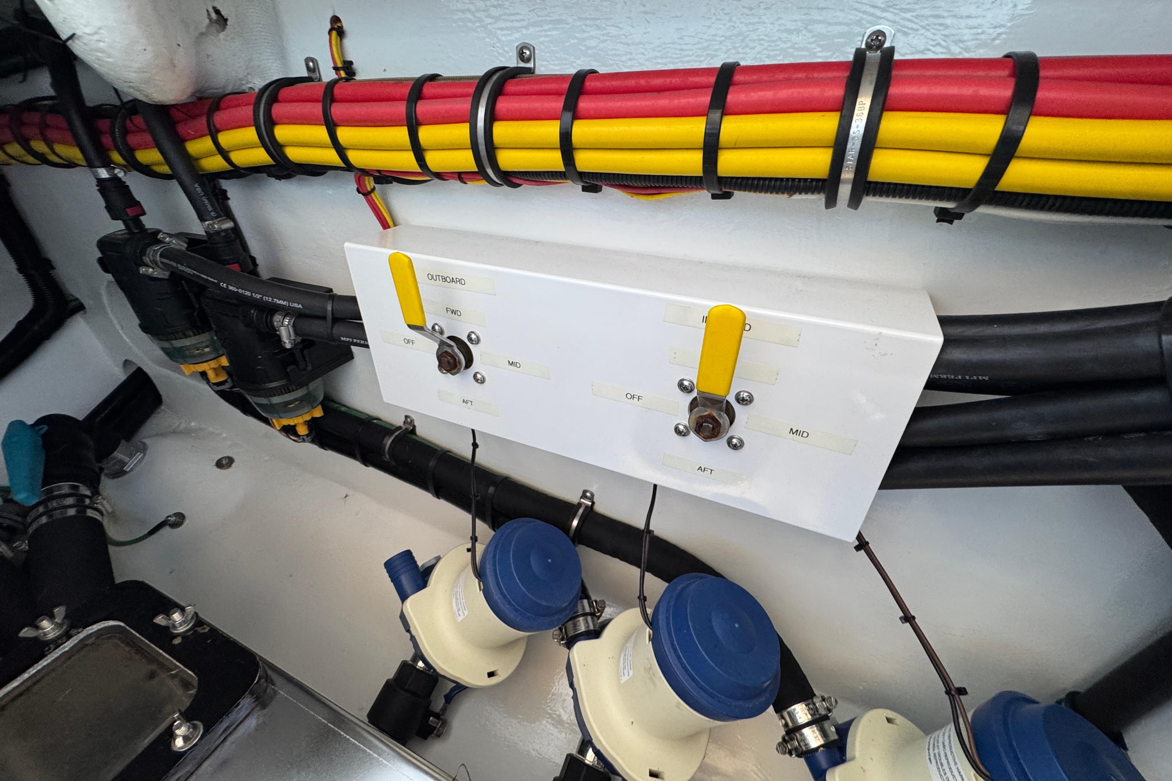 2022 Nor-Tech 392 Super Fish engine compartment with wiring and control panel.