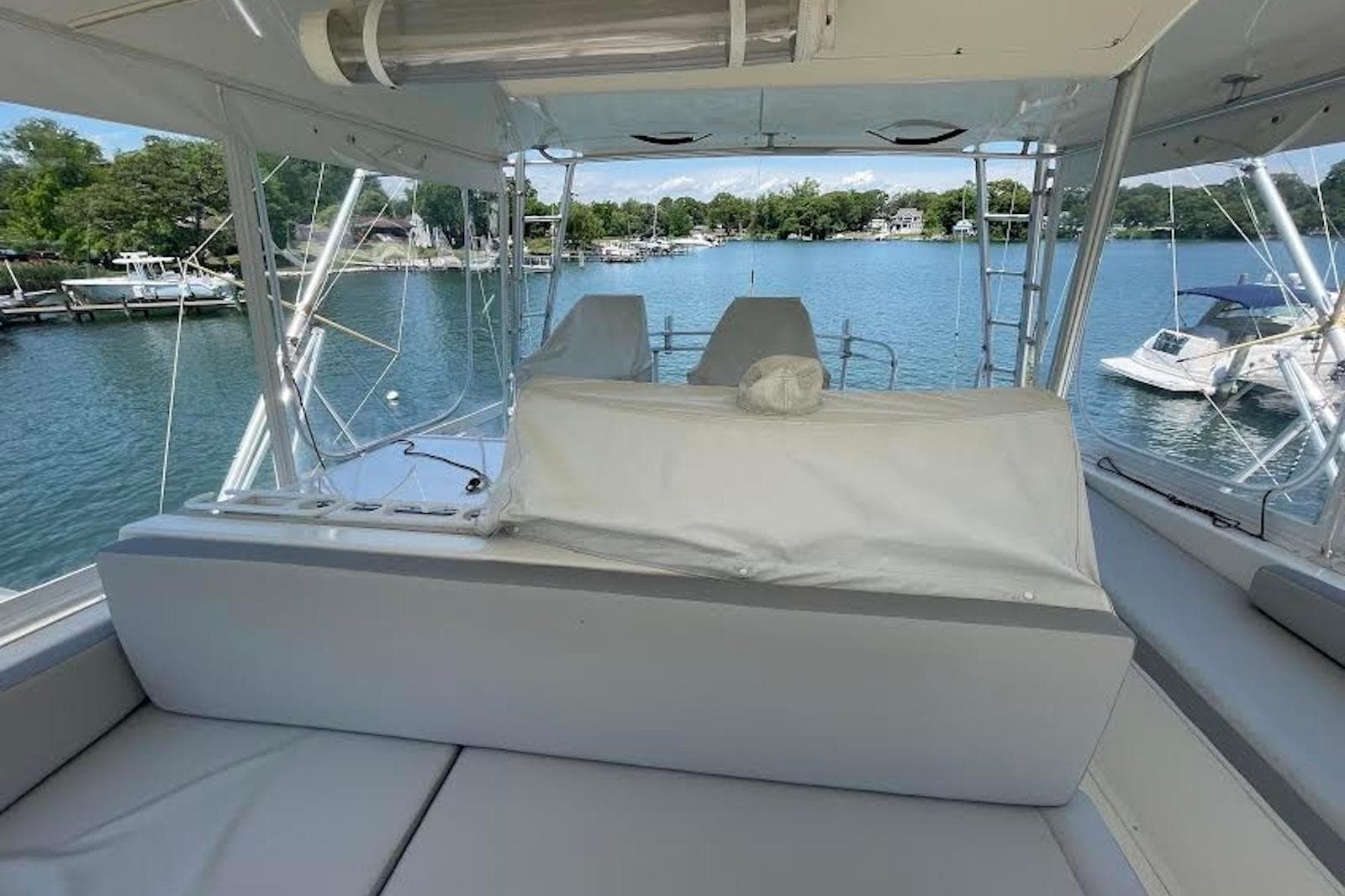 Interior view of a 1990 Viking 53 Convertible yacht overlooking a serene marina.