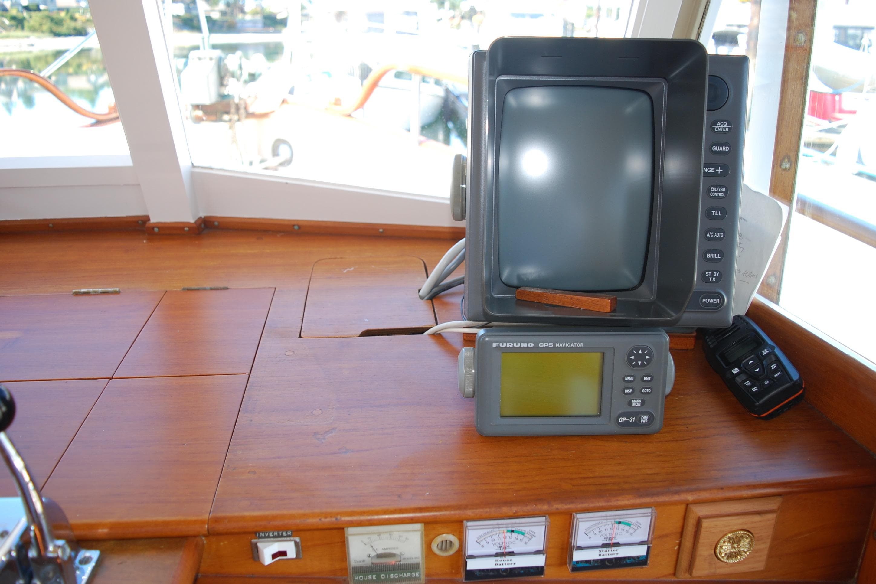 1971 Grand Banks 36 Classic helm with navigation equipment and wooden dashboard.