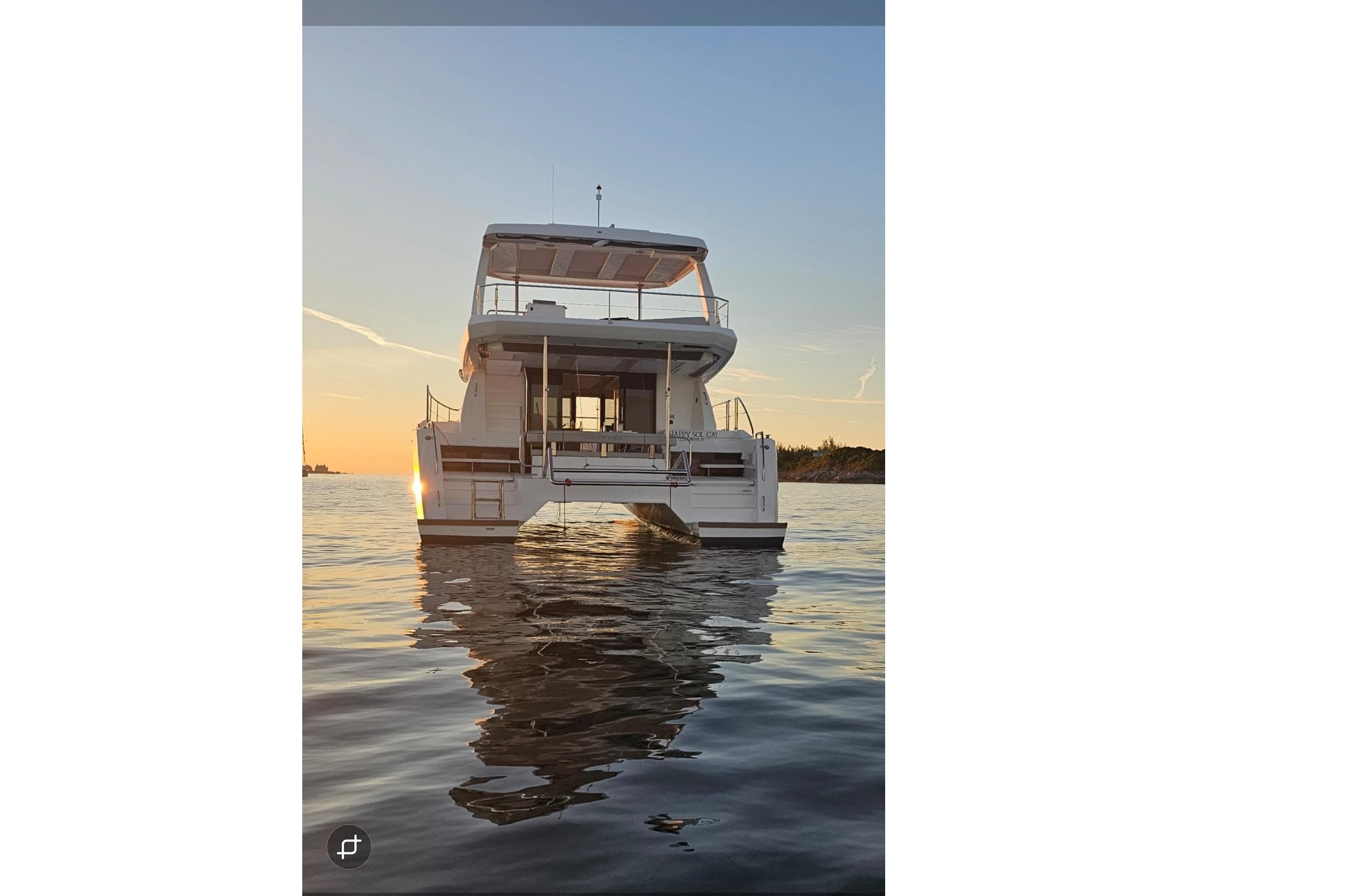 2024 Leopard 40 Powercat yacht on calm water at sunset.