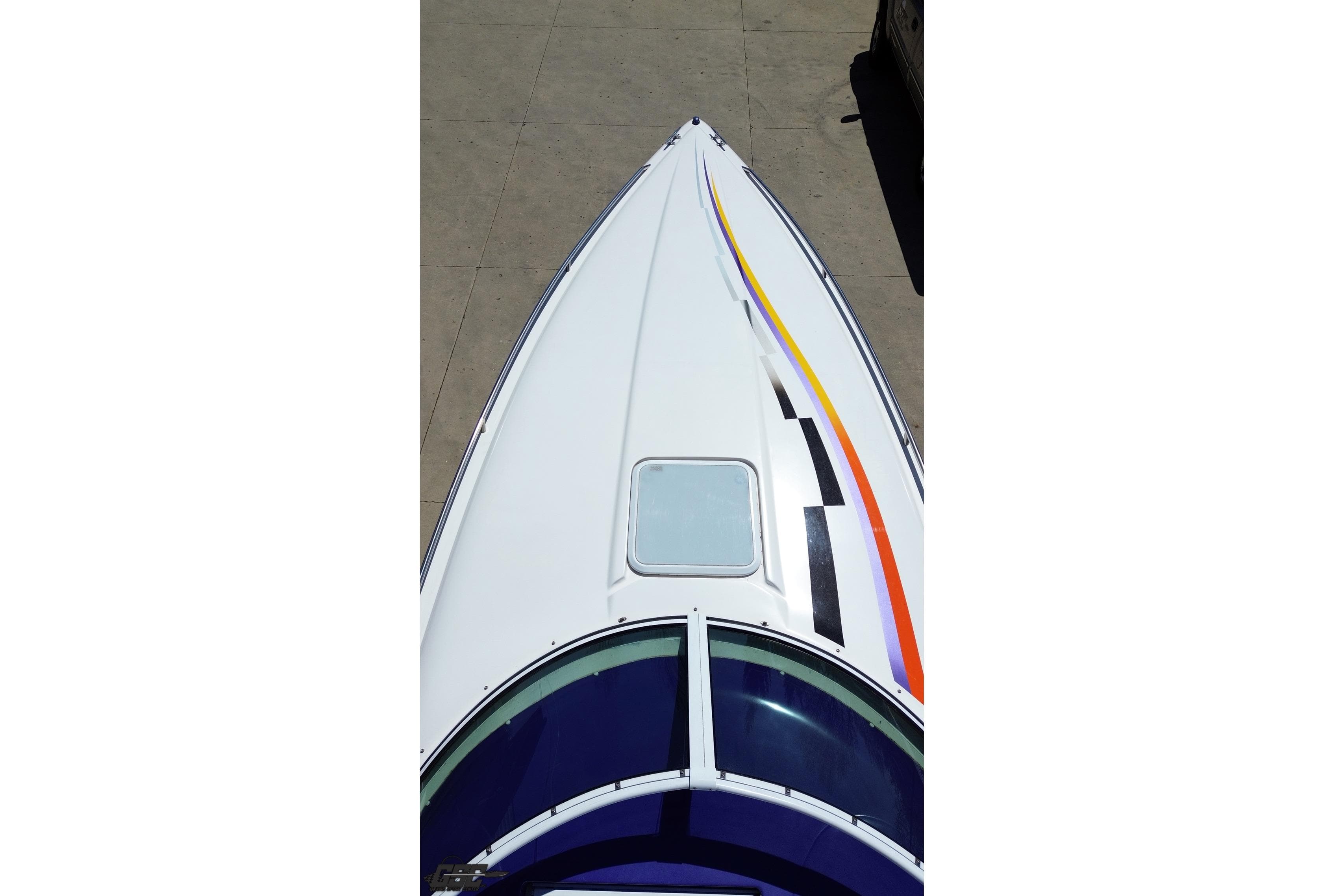 Top view of 2001 Powerquest 340 Vyper boat with colorful stripes.