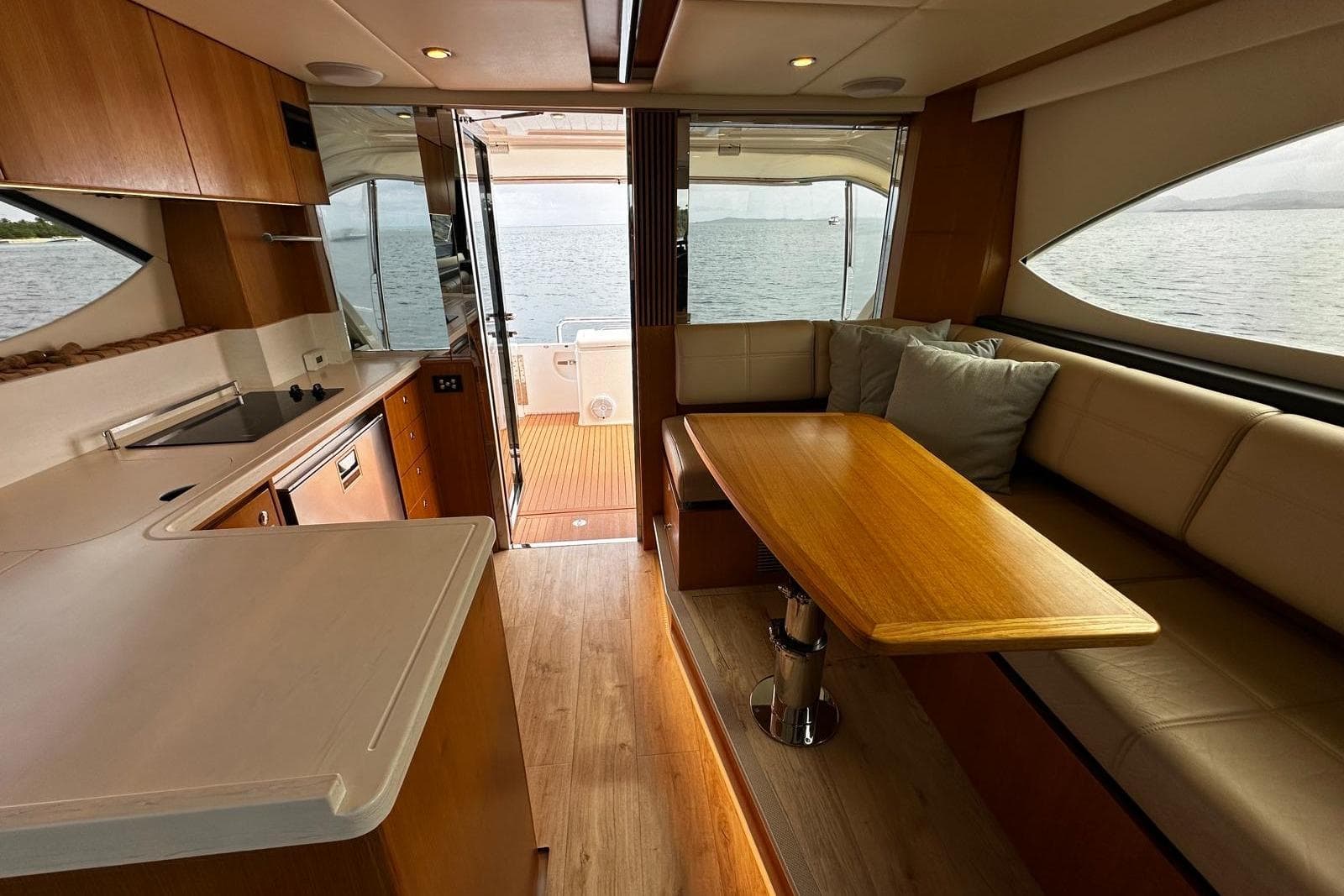 Interior of 2020 Riviera 395 SUV yacht with modern kitchen and cozy seating area.