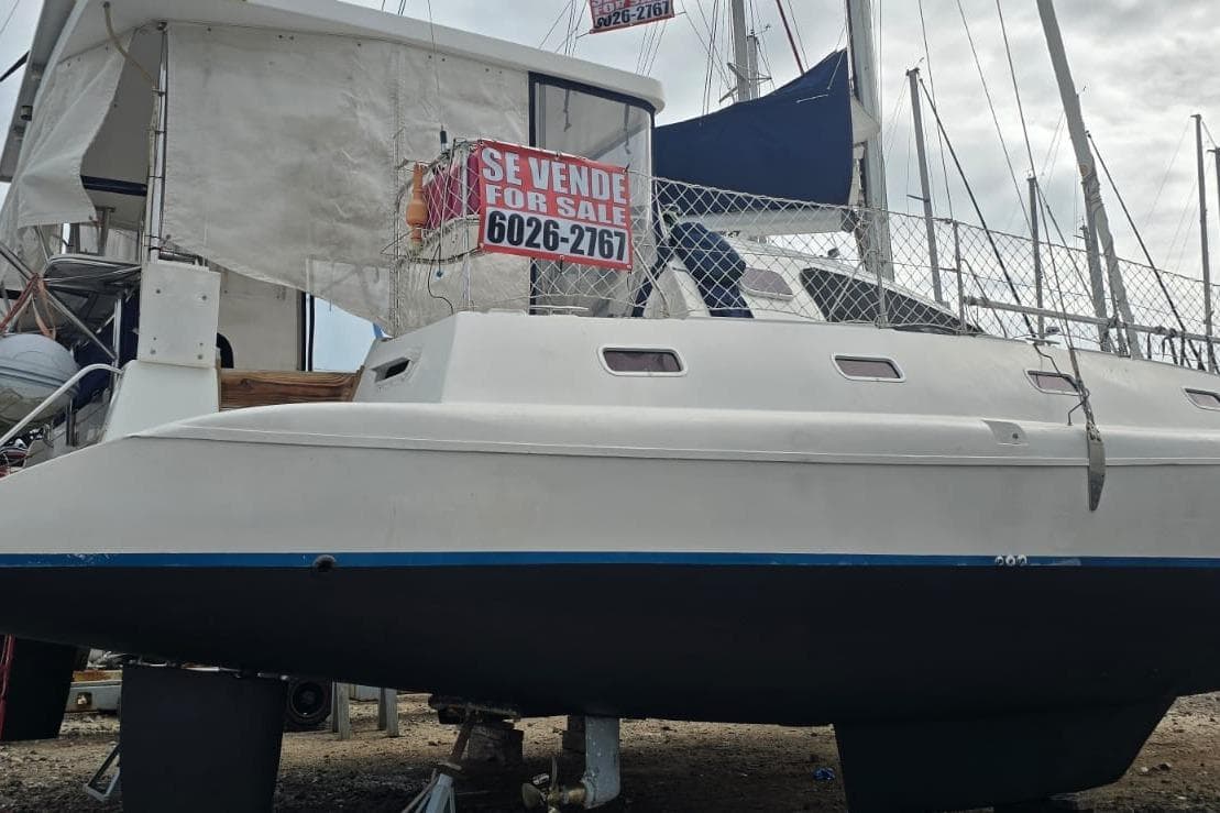 2005 Fortuna Island Spirit 401 catamaran for sale, displayed on land with contact number.