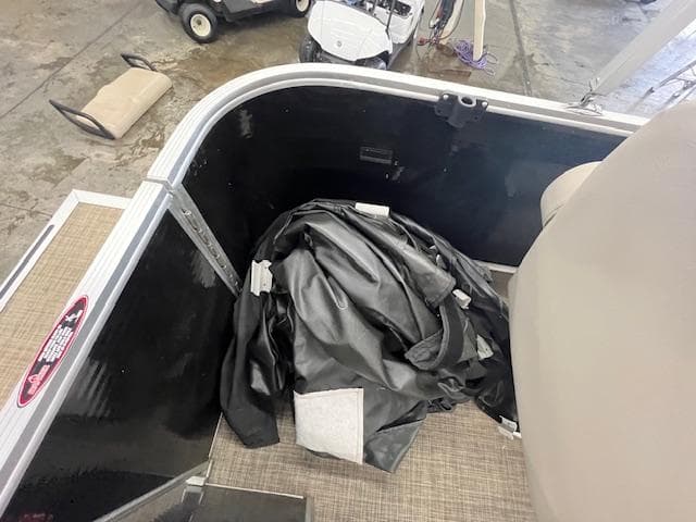 2017 Harris Cruiser 200 interior with folded black cover on floor.