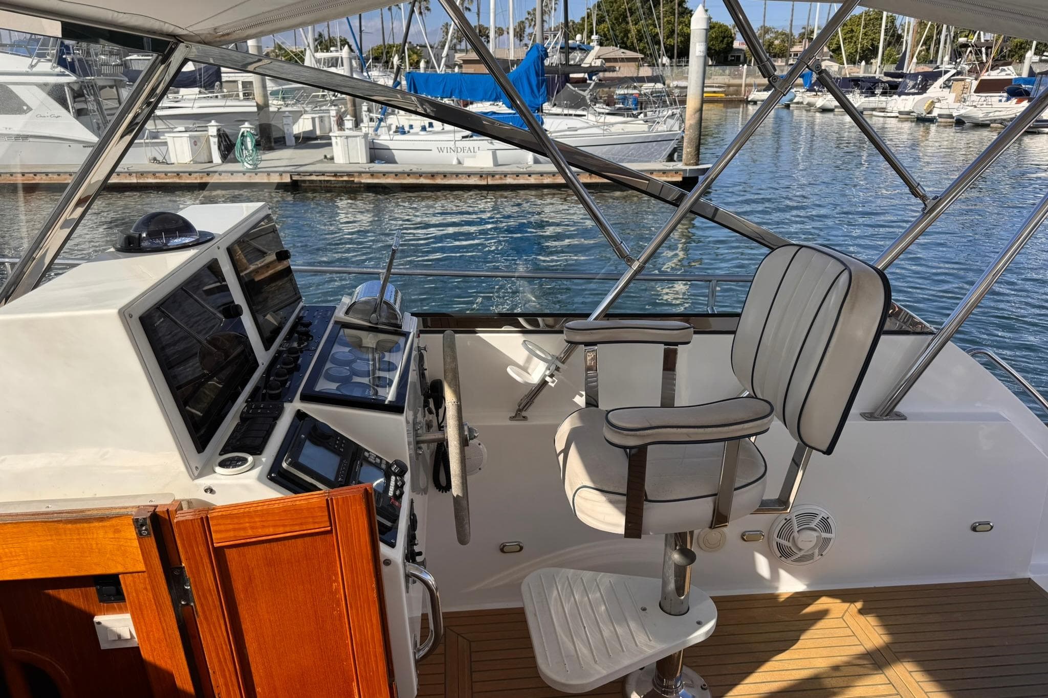 1999 Grand Banks 38 Eastbay EX helm with controls and captain's chair at marina.