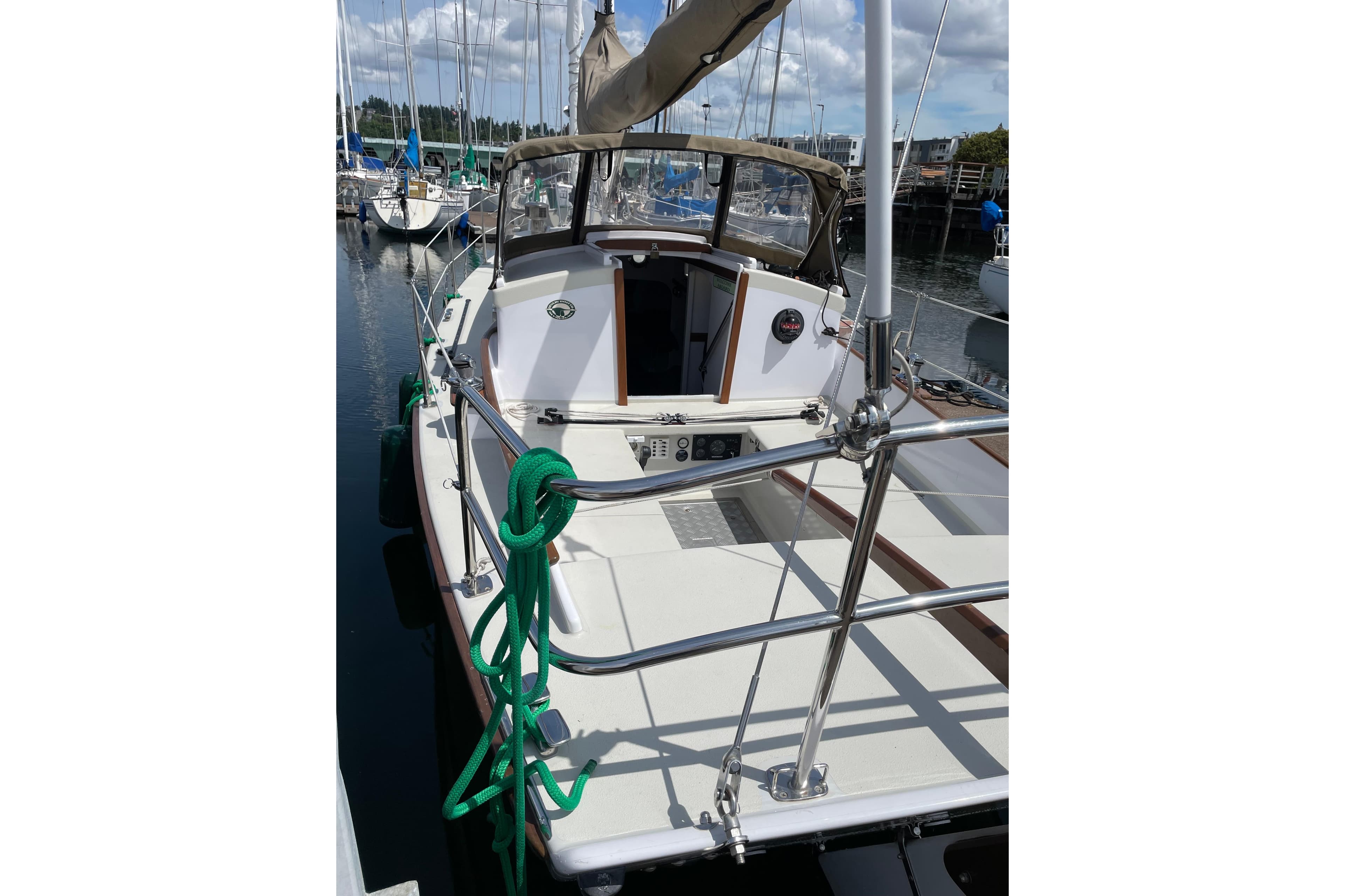 2013 Devlin Onyx sailboat docked at marina, featuring green rope and sleek design.