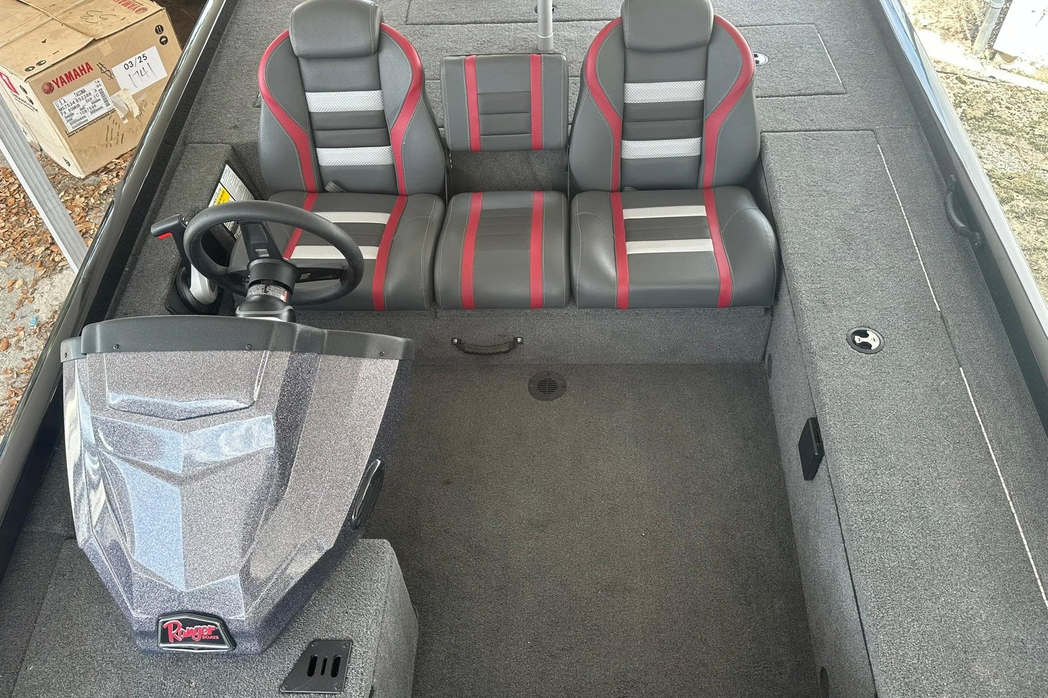2025 Ranger RT188C boat interior with dual seats, steering wheel, and carpeted flooring.