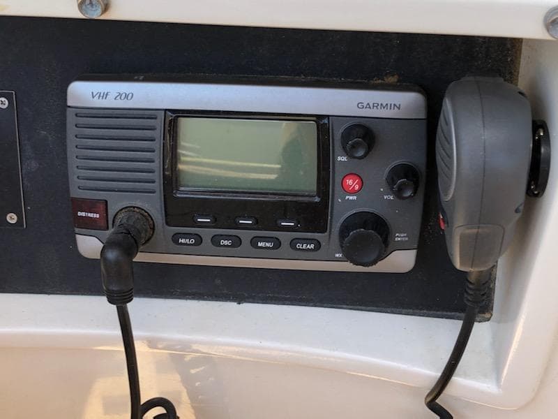 VHF 200 Garmin radio on 2000 Cherubini Schooner, featuring microphone and control panel.