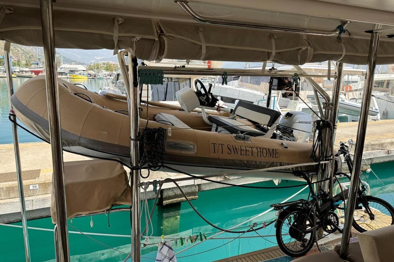 Inflatable boat "T/T Sweet Home" on Leopard 45 catamaran, docked at marina, 2019 model.
