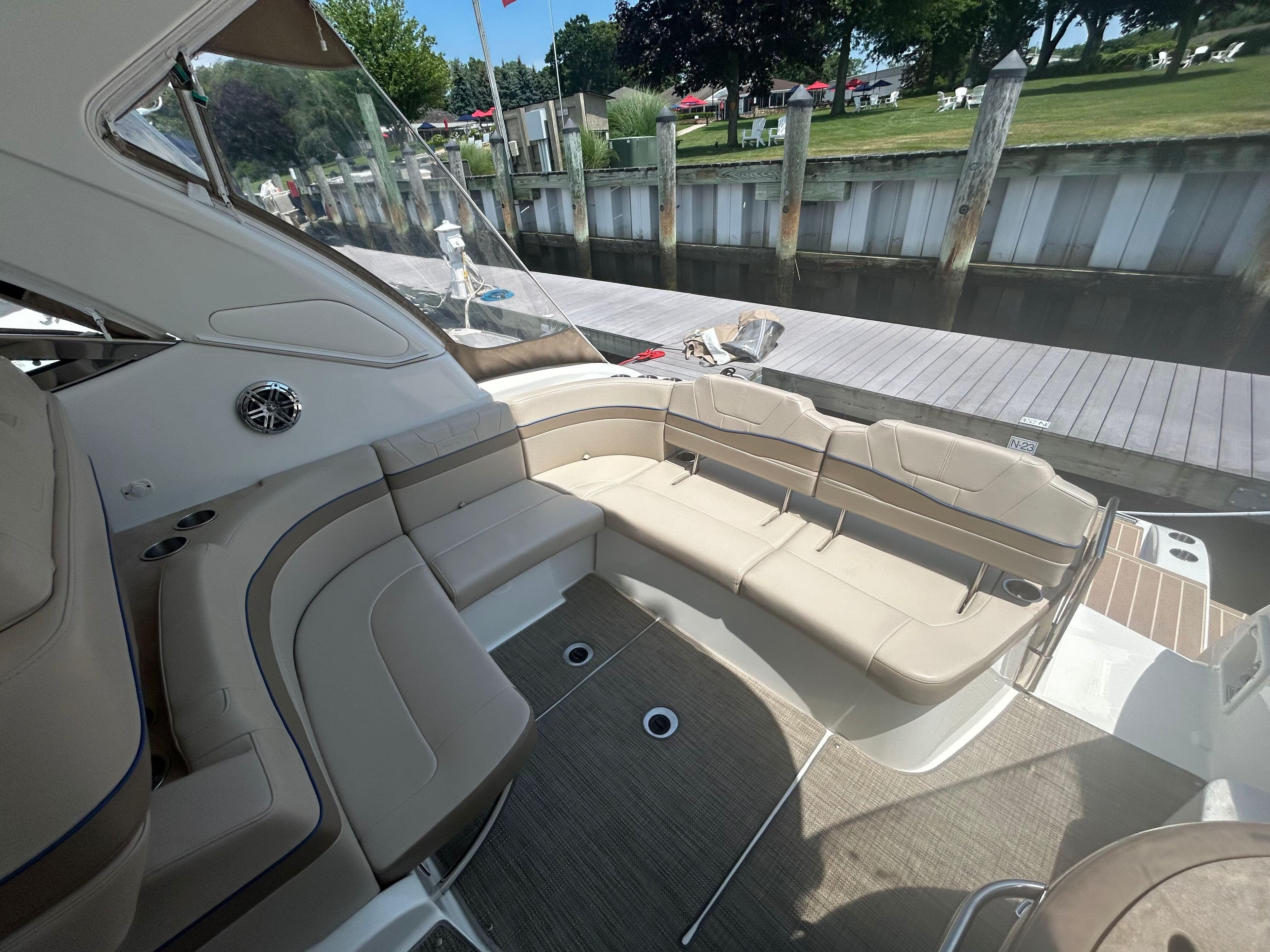 2021 Formula 34 Performance Cruiser with spacious seating, docked by a wooden pier.