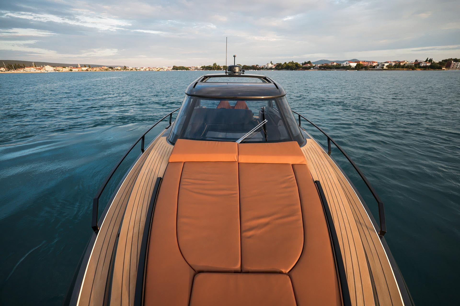 Luxurious Focus 3X 2025 yacht cruising on serene waters under a cloudy sky.