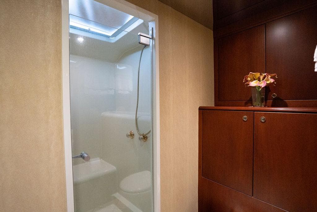 Luxurious bathroom in 2004 Cheoy Lee 84 Bravo Flybridge yacht with elegant wood cabinetry.