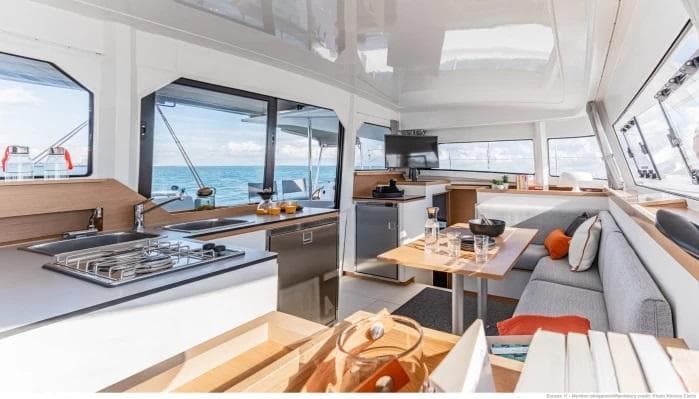 Manufacturer Provided Image: Luxurious interior of 2026 Excess 11 catamaran with modern kitchen and seating area.