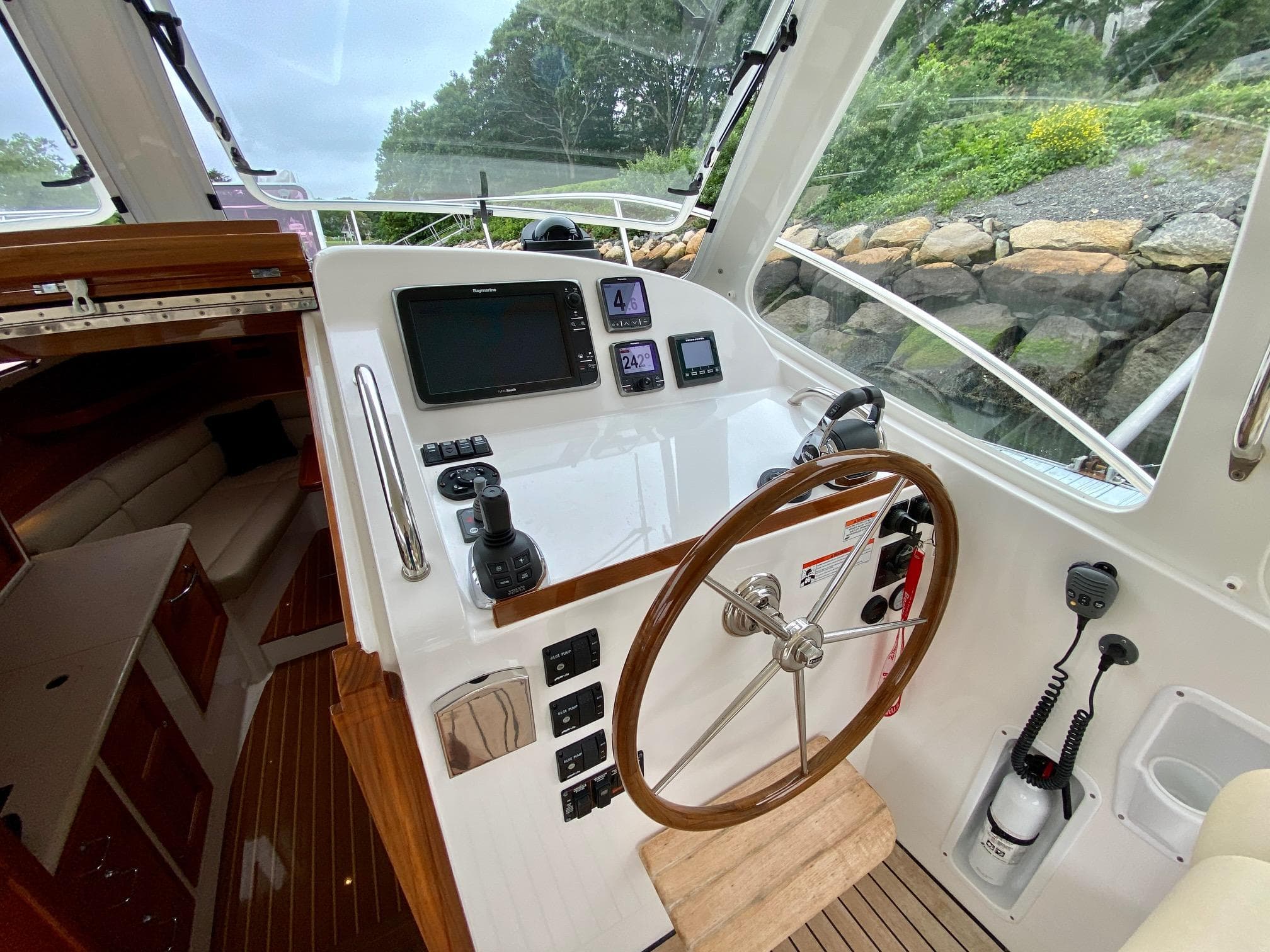 2013 MJM 36z Downeast boat helm with steering wheel and navigation controls.