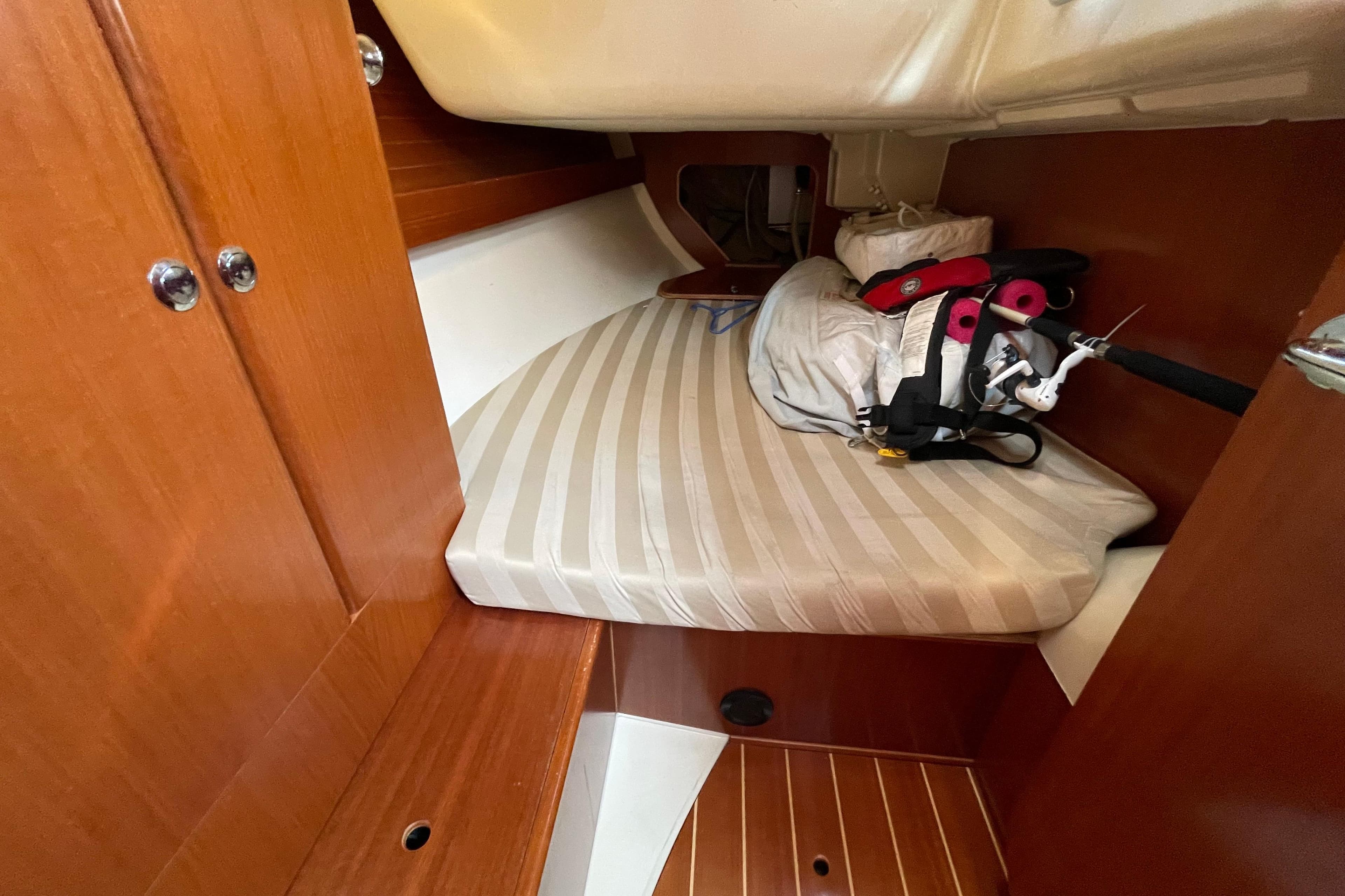 Cozy cabin interior of 2004 Dufour 40 Performance sailboat with striped mattress.