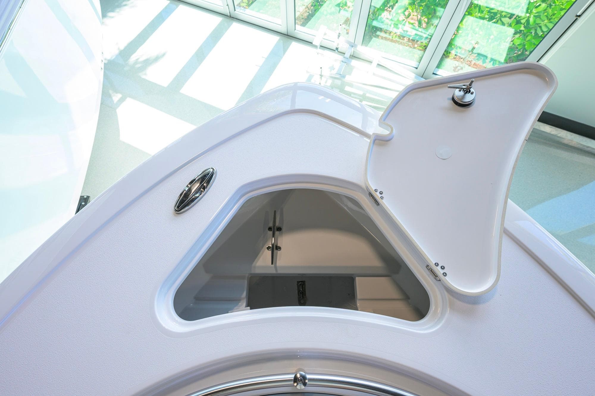 Open storage compartment on 2026 Sportsman Open 232 Center Console boat, showcasing interior space.