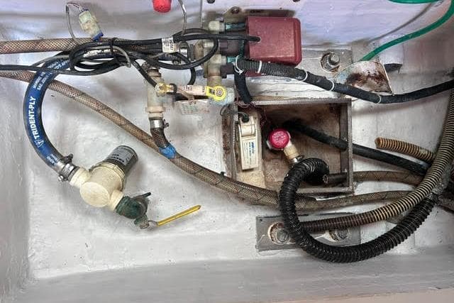 Electrical and plumbing components in a 2007 Jeanneau Sun Odyssey 42 DS yacht.