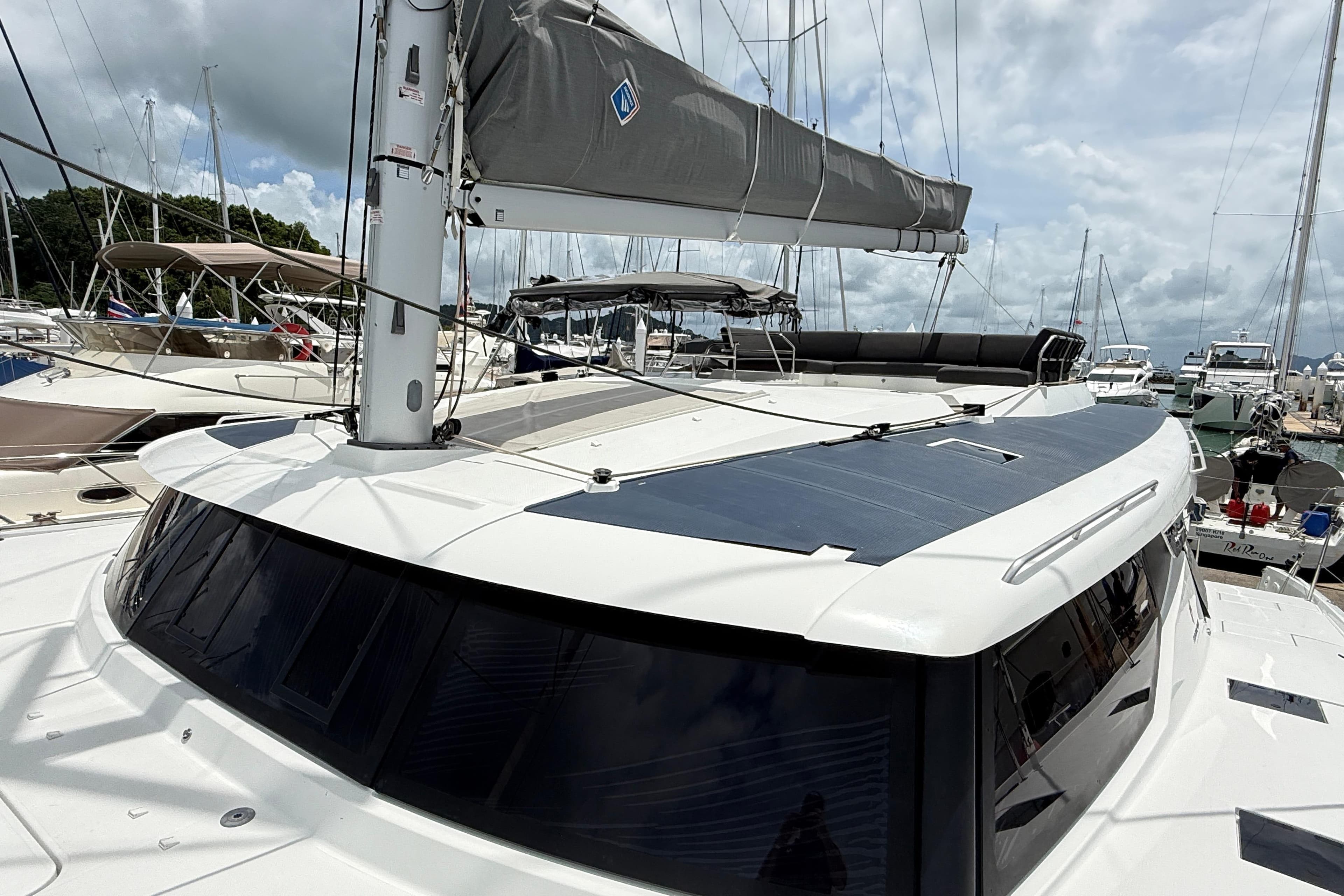 2025 Fountaine Pajot Tanna 47 catamaran docked at marina under cloudy sky.