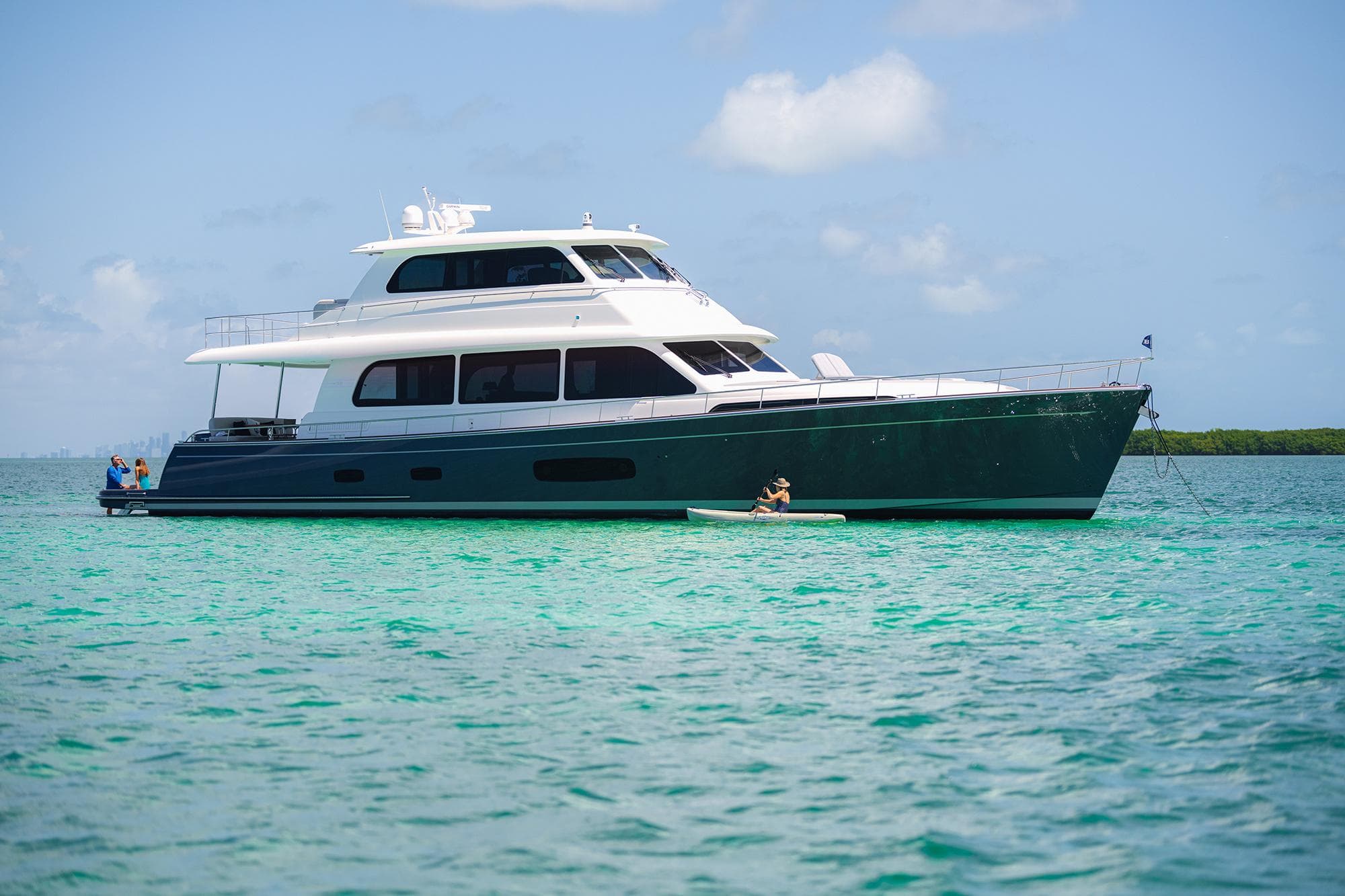 2026 Grand Banks GB 85 yacht on turquoise water under blue sky.