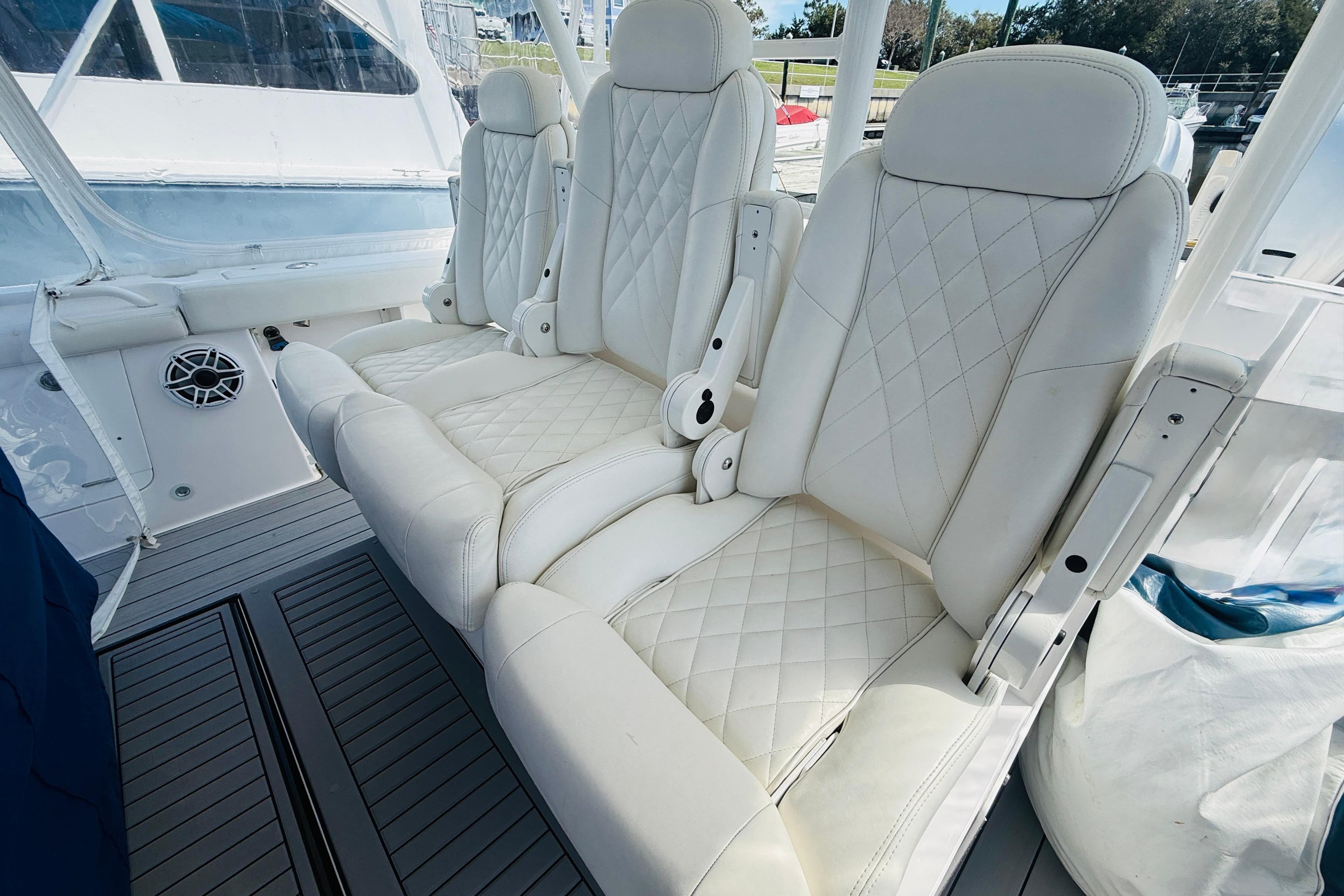 Luxurious white seating on 2021 Everglades 395 Center Console boat, featuring diamond stitching.