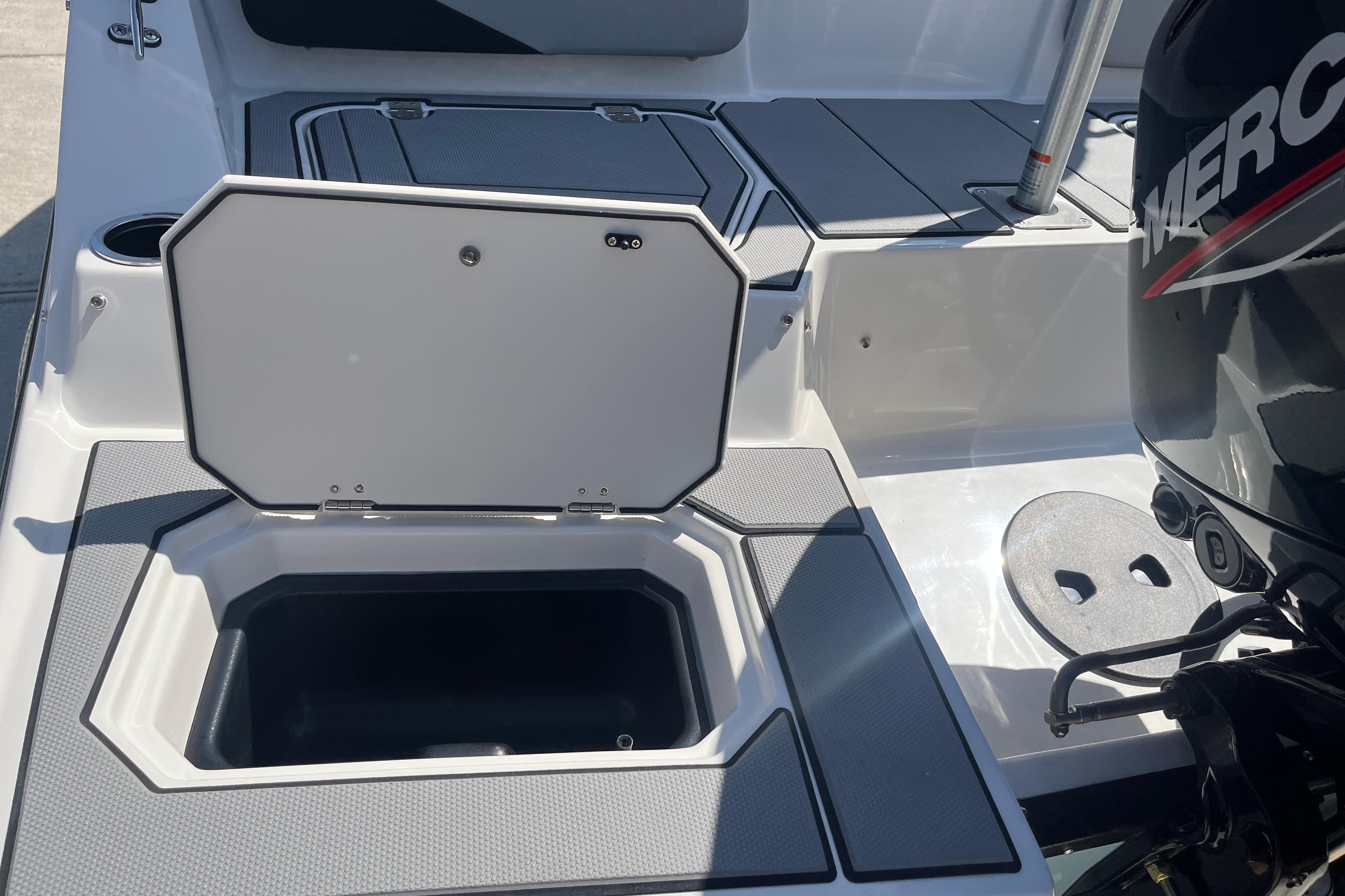 2026 Starcraft SV 16 OB boat with open storage compartment and Mercury outboard motor.