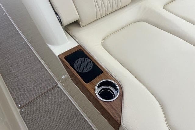2026 Chris-Craft Catalina 31 interior with beige seating, wood accents, and cup holder.
