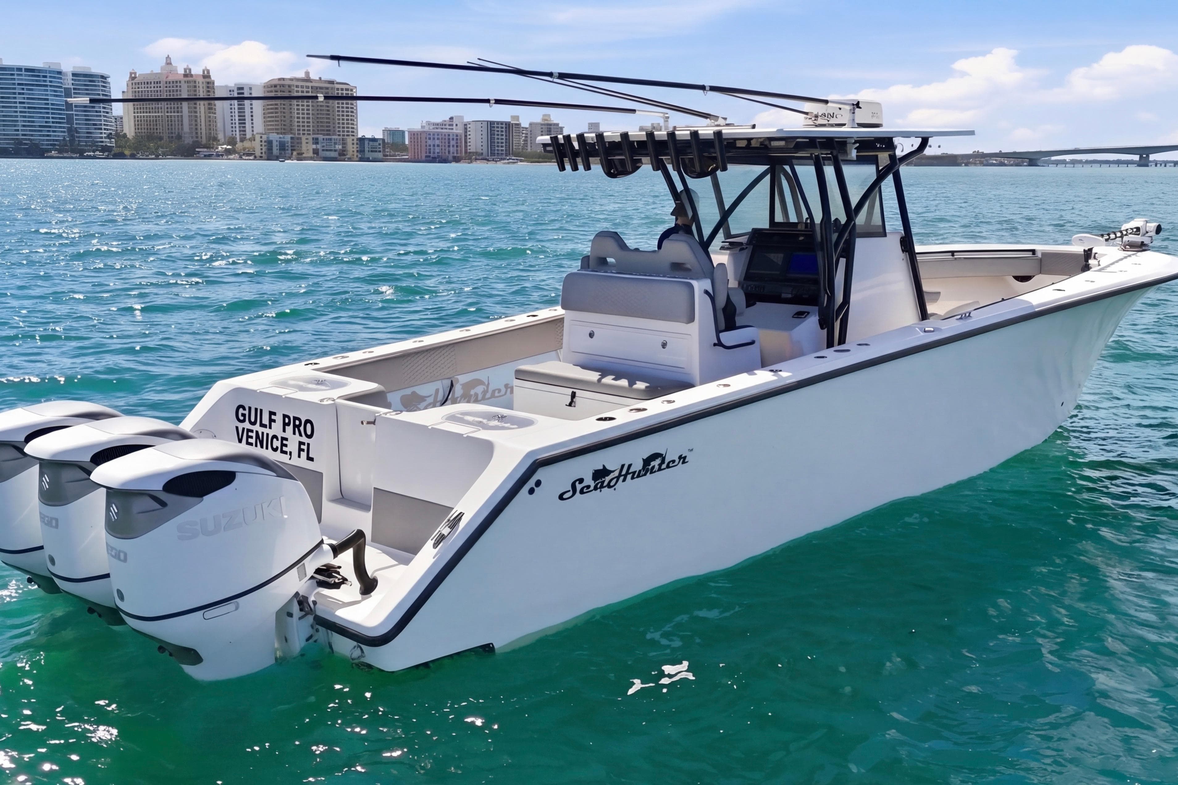 2016 SeaHunter 35 Tournament boat on clear blue water, featuring triple Suzuki engines.