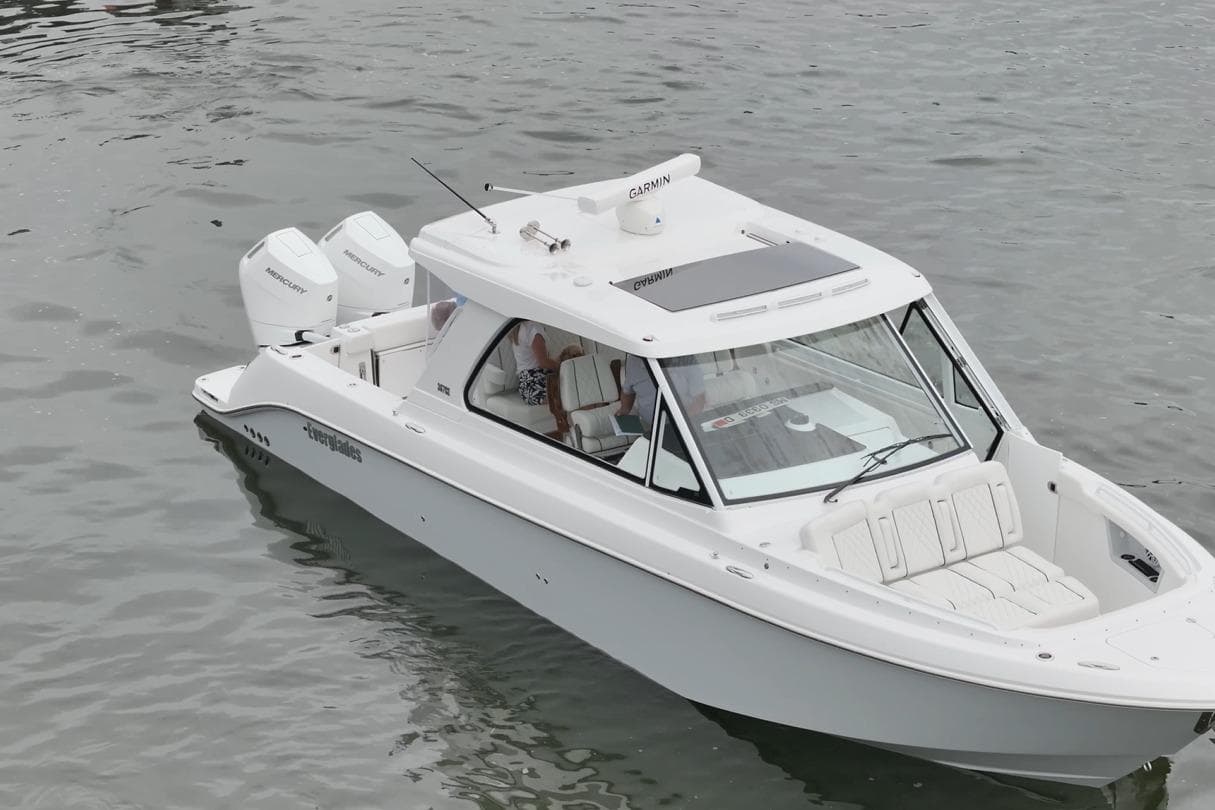 2026 Everglades 367 CX boat on water, featuring sleek design and dual Mercury engines.