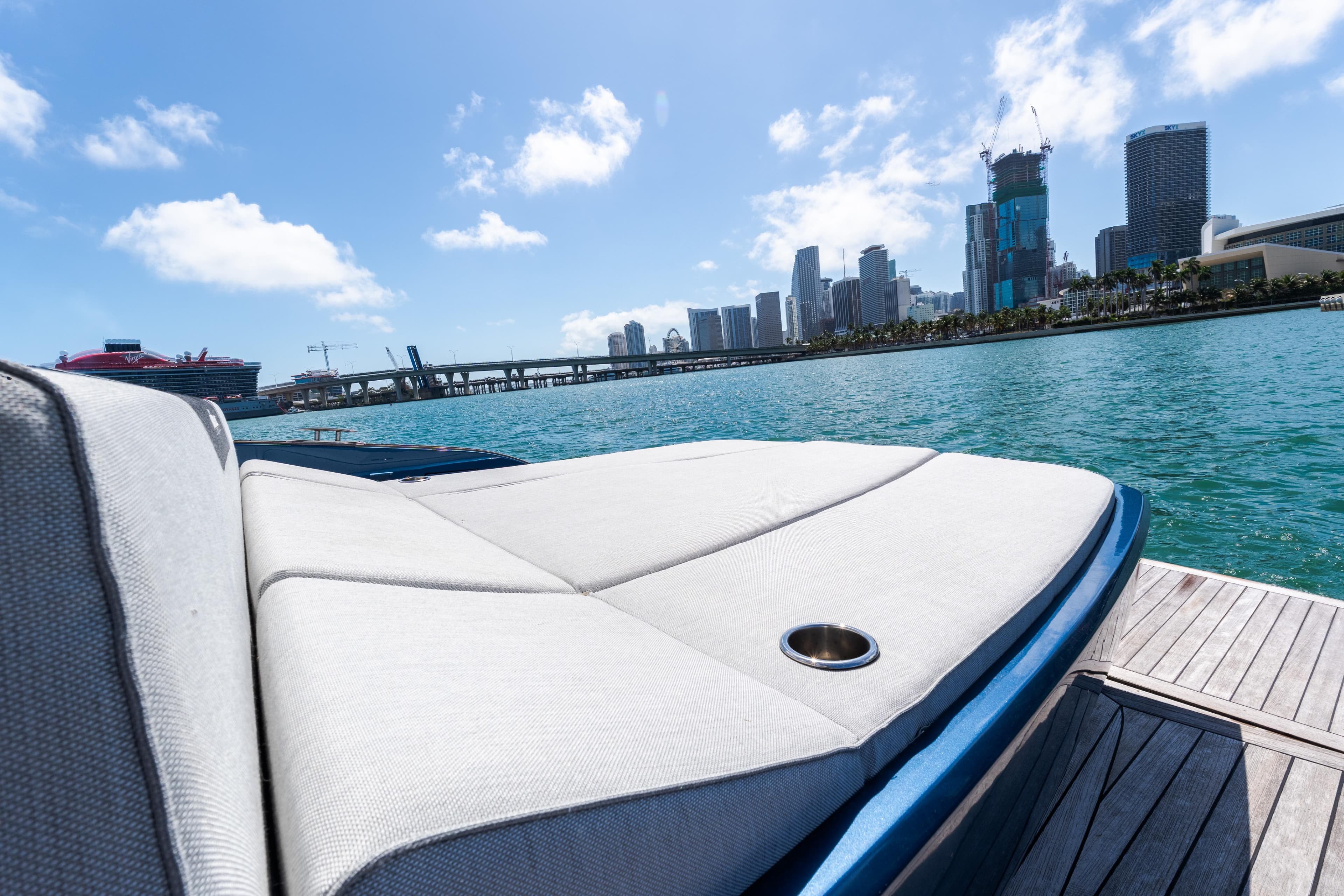 2023 Solaris Power 44 Open yacht with city skyline and ocean view.