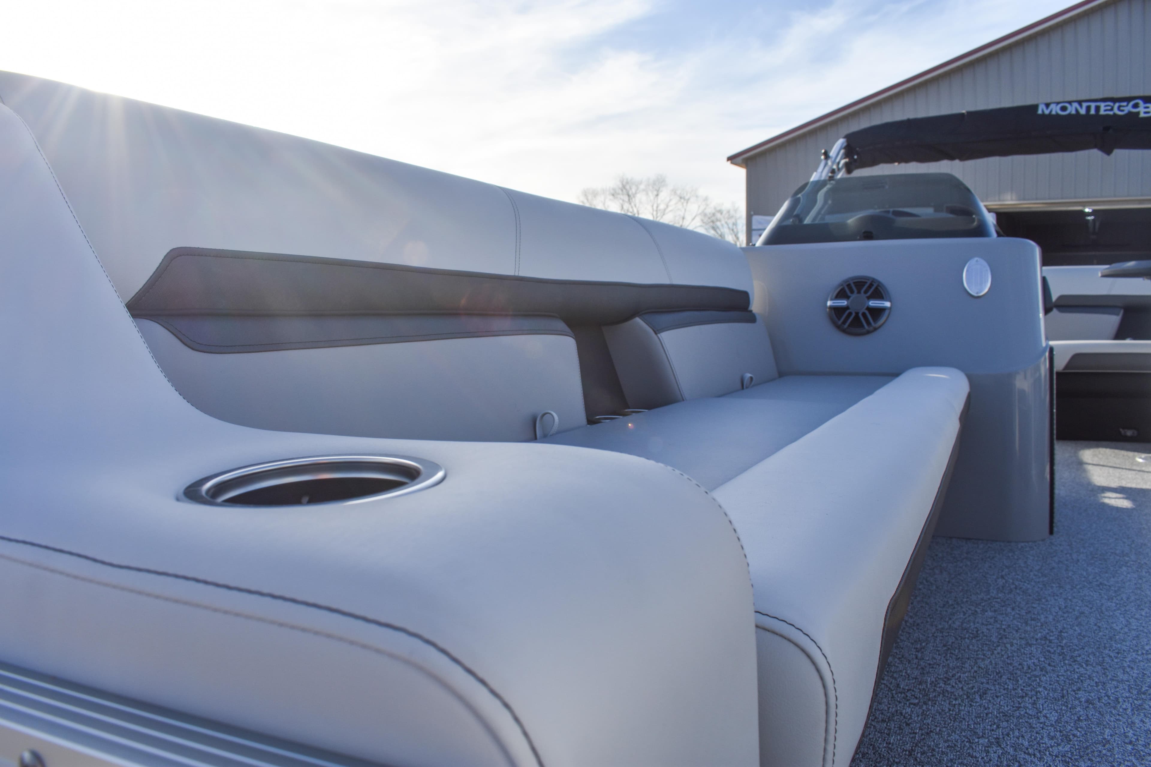 2025 Montego Bay 90HP C8520 STD Cruise Pontoon interior with plush seating and cup holder.