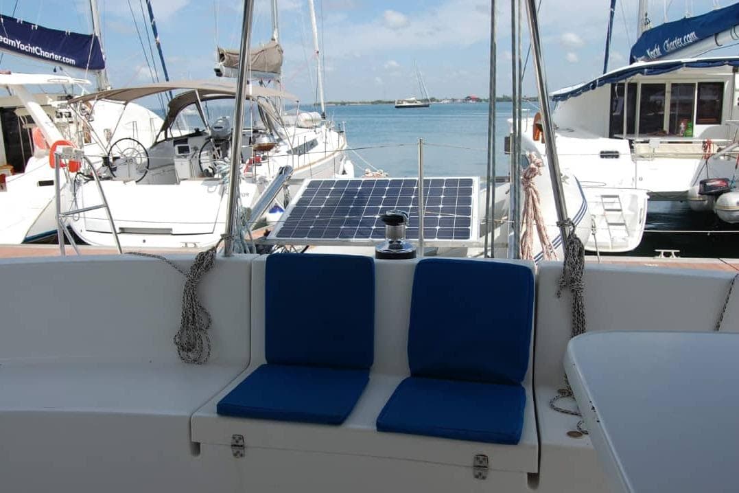 2006 Fountaine Pajot Belize 43 catamaran cockpit with blue cushions and solar panel.