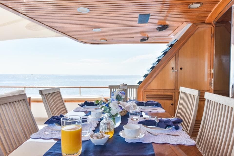 Elegant dining setup on 1984 W.A. Souter & Sons yacht, ocean view.