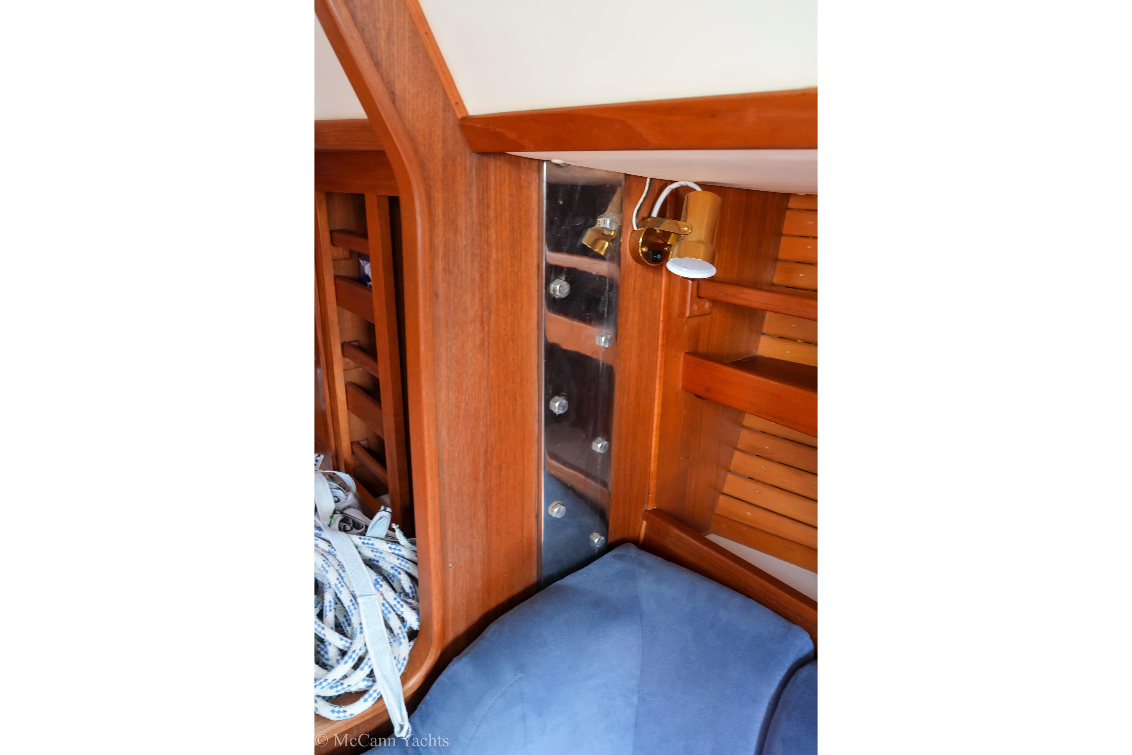 Interior of 1989 Nordic 40 yacht with wooden paneling and nautical ropes.