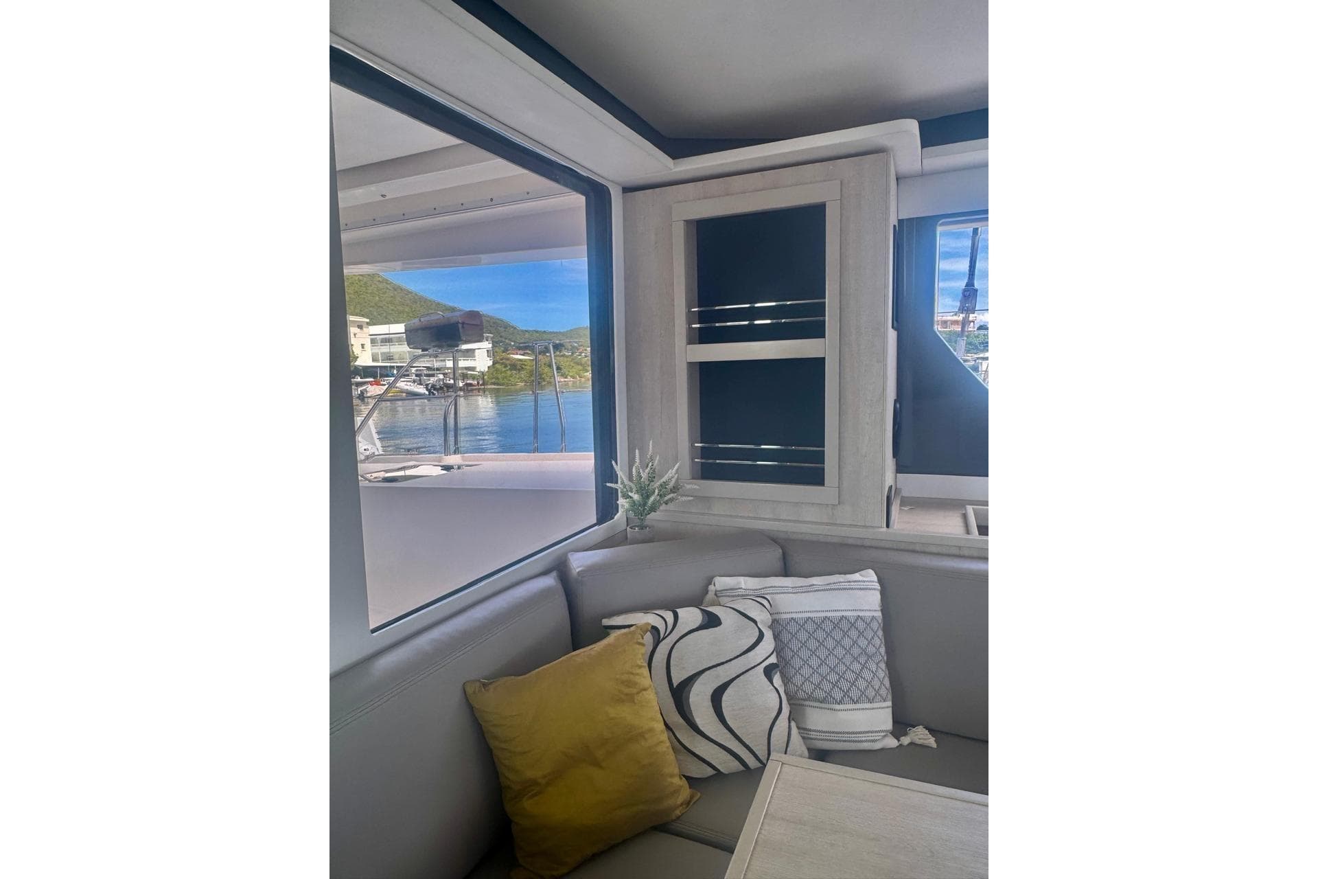 Interior of 2017 Leopard 45 yacht with cozy seating and scenic window view.