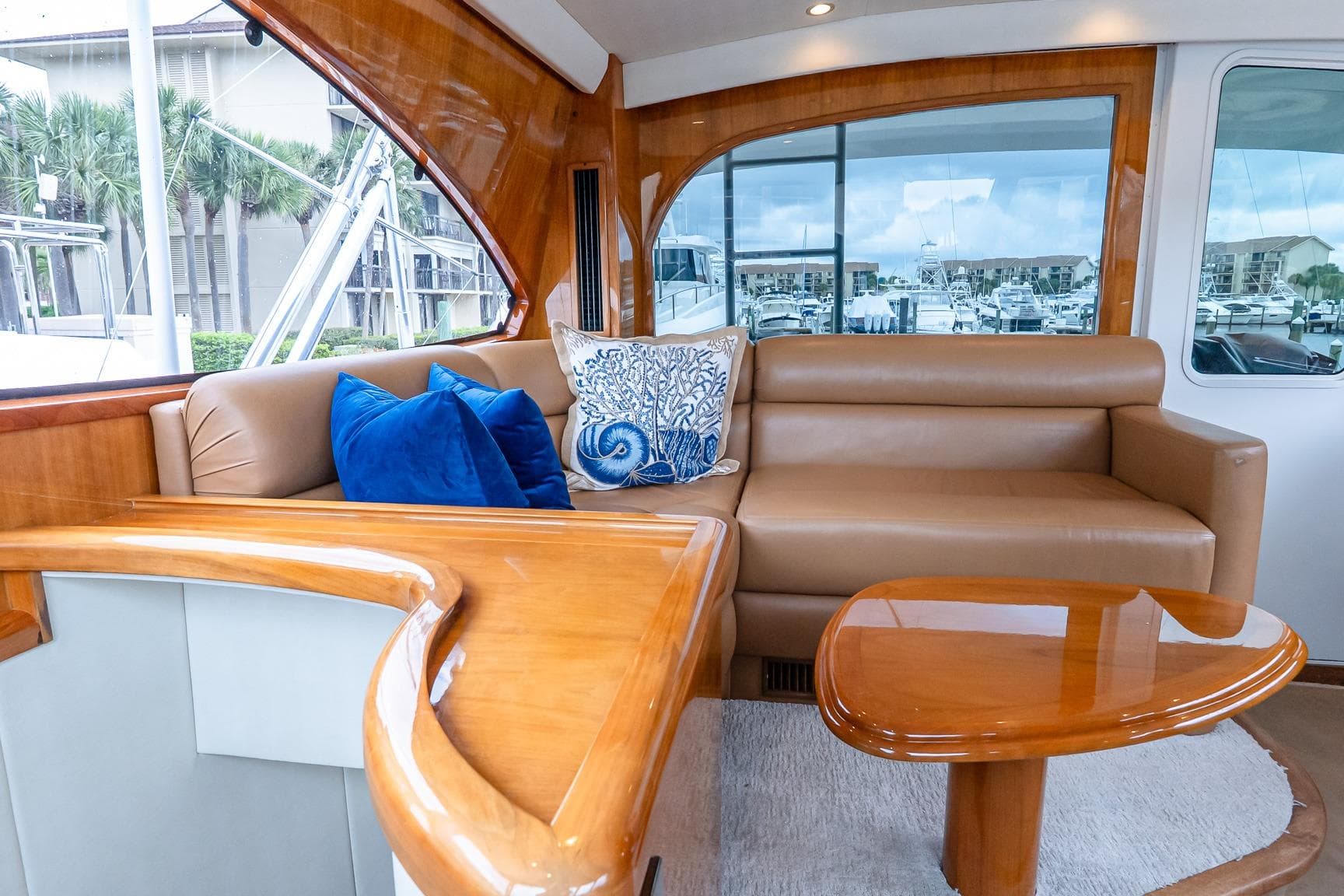 Luxurious interior of 2017 Viking 62 Enclosed Bridge yacht with plush seating and elegant wood finishes.