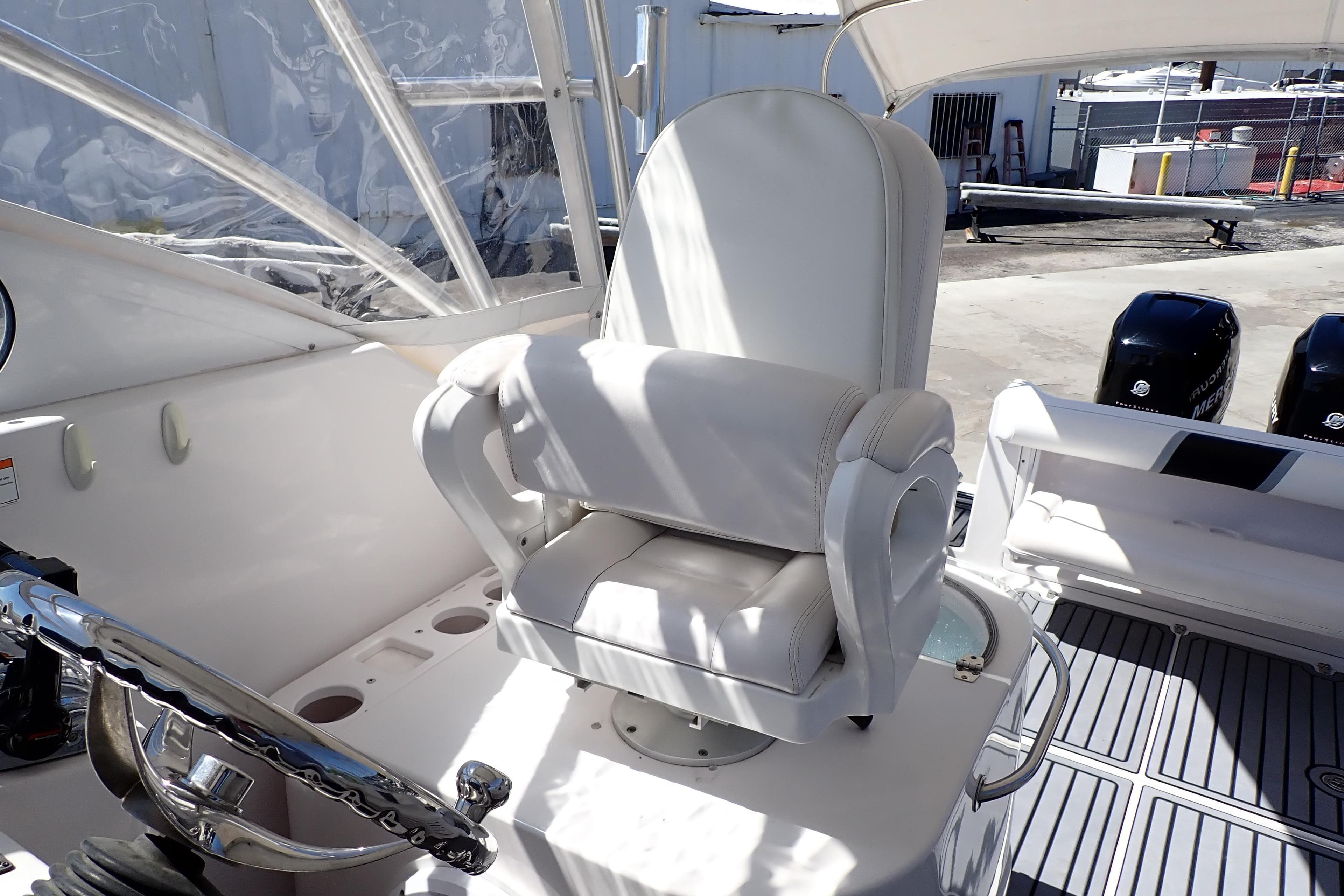 Captain's chair on 2014 Pro-Line 32 Express boat, featuring sleek design and modern controls.