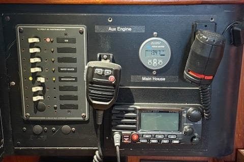 Control panel of a 1995 Island Packet 37 sailboat with communication equipment.