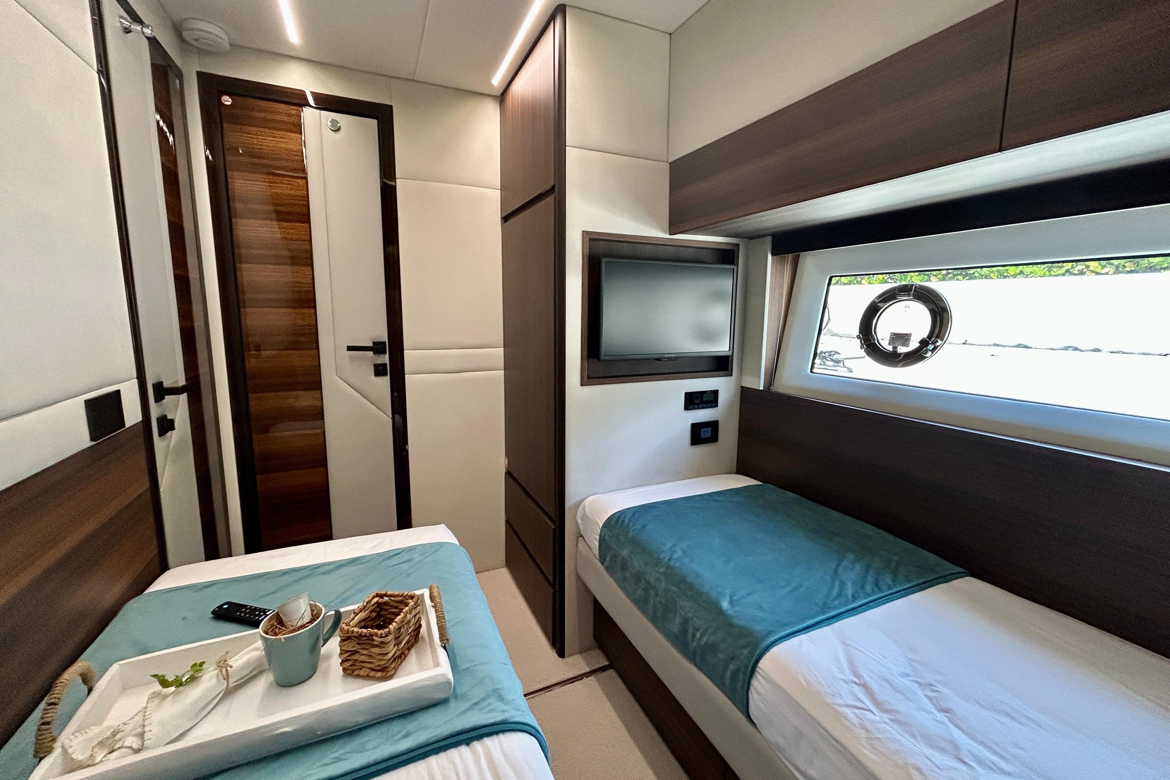 Luxurious cabin interior of 2024 Aicon Vivere 66 yacht with twin beds and modern decor.