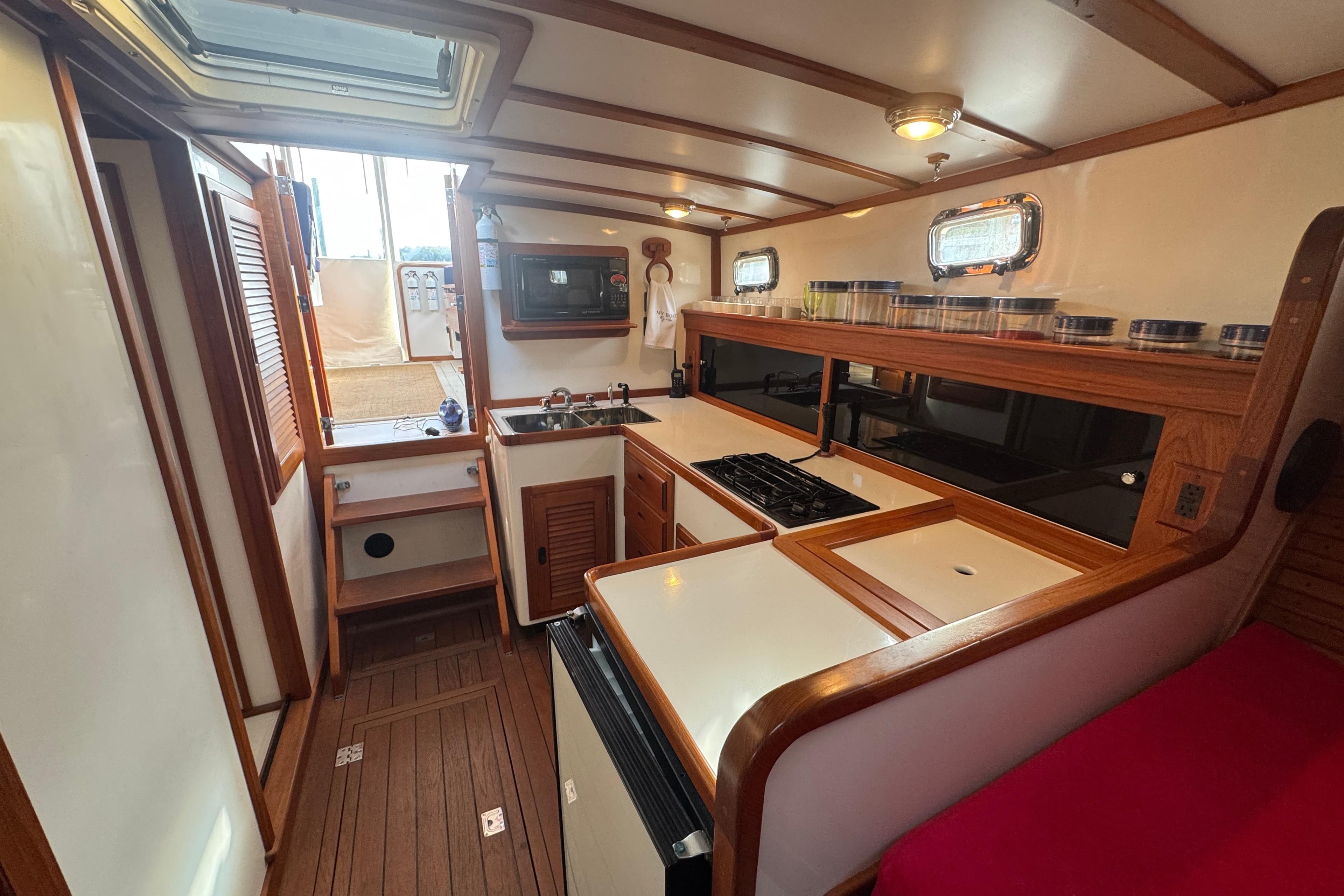2001 Ellis 36 Flybridge yacht interior with kitchen, wooden cabinetry, and modern appliances.