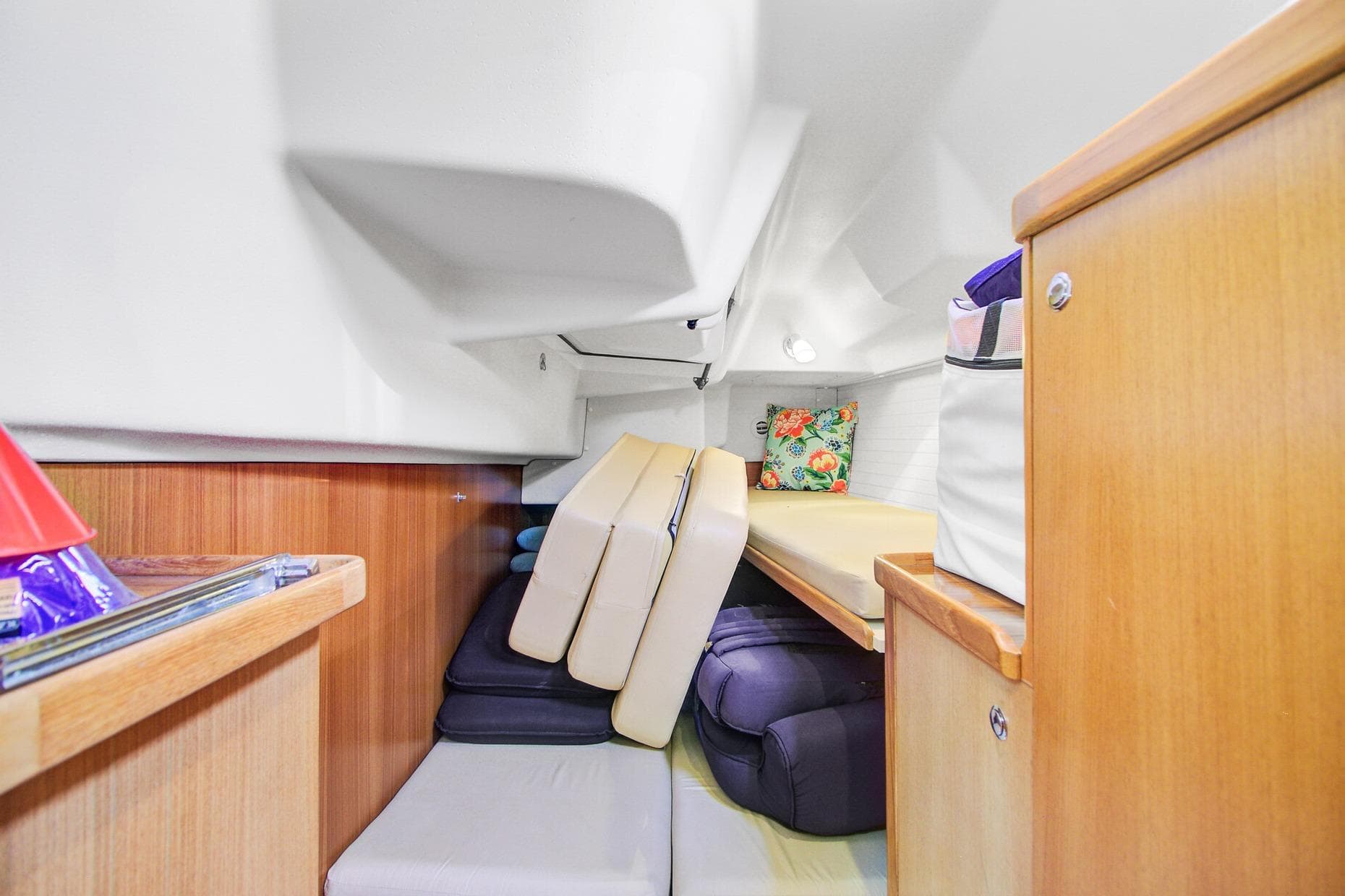 Interior cabin of 2011 Catalina 445 sailboat with cushions and wooden cabinetry.