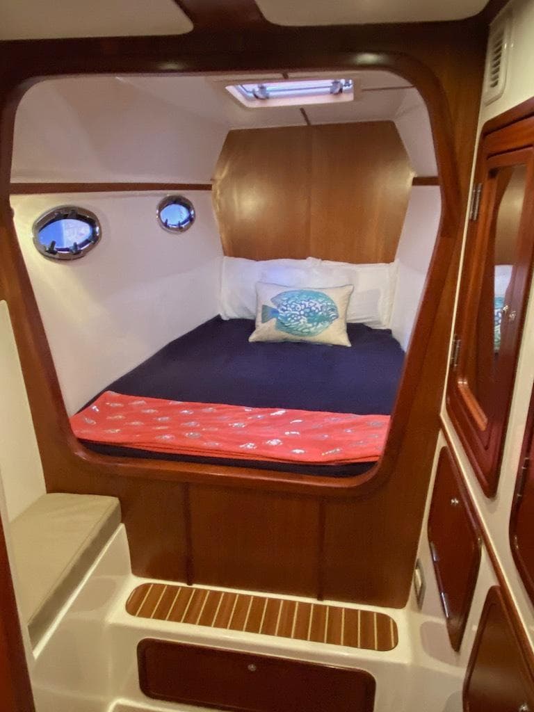 2013 Africat Marine AfriCat PowerCat Sportfisher cabin with cozy bed and wooden interior.