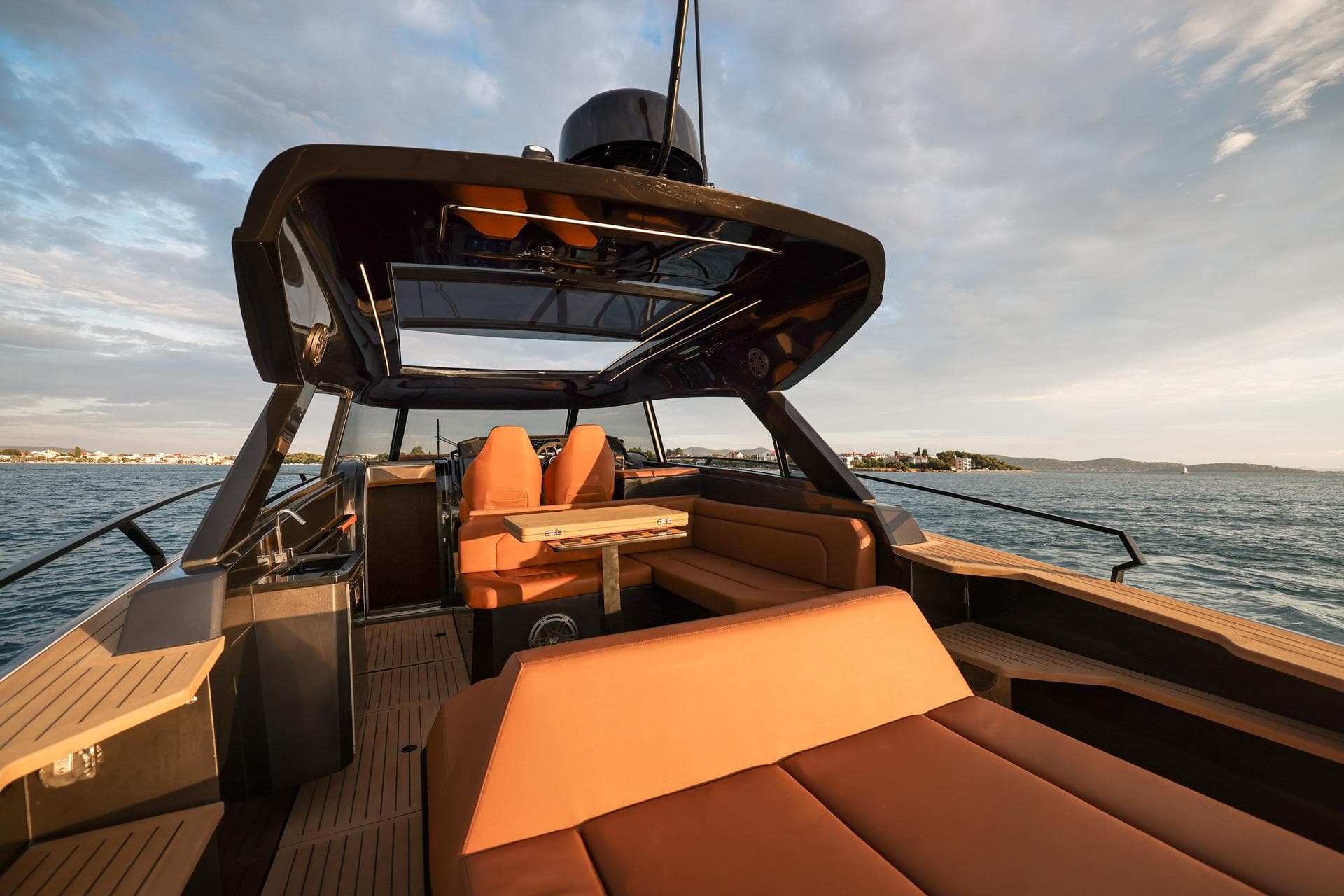 Luxurious 2025 Focus 3X yacht interior with sleek design and comfortable seating on open water.