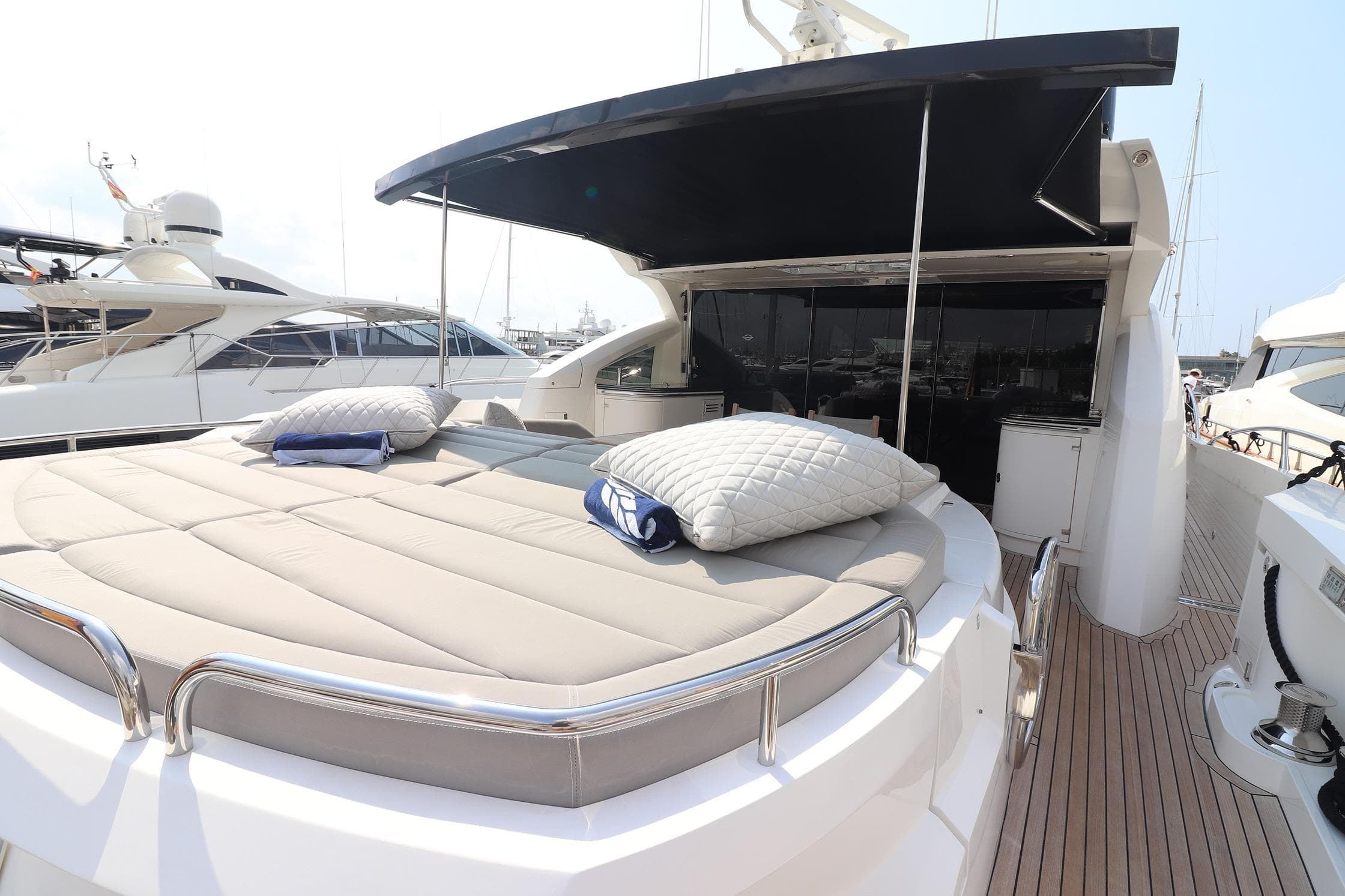 Luxurious 2013 Sunseeker Predator 80 yacht with spacious sunbathing deck and elegant design.