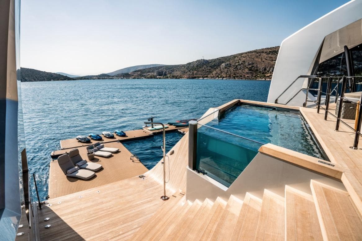 Luxurious 2024 Tecnomar Custom yacht with pool and sun deck on serene waters.