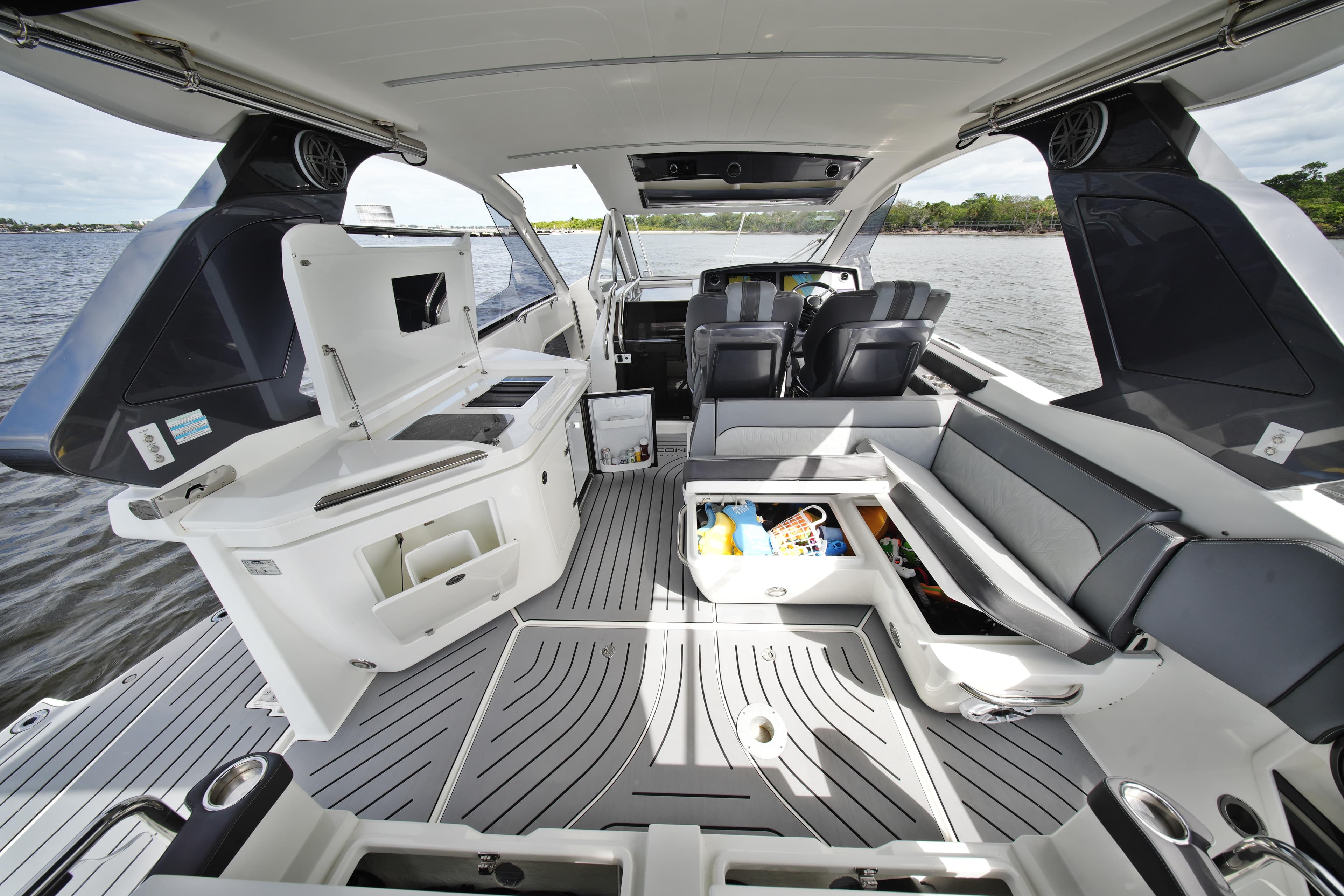 2023 Galeon 400 XL yacht interior with seating, storage, and helm on open water.