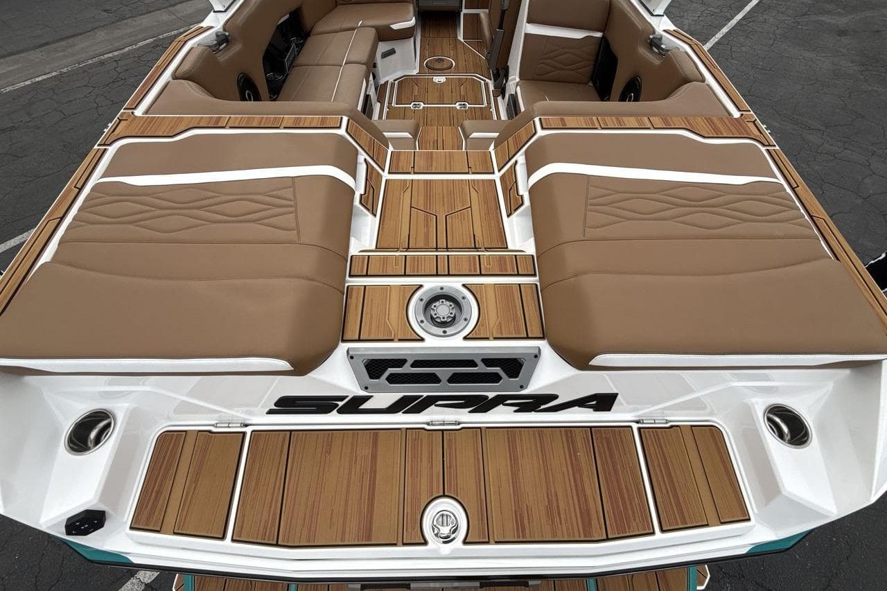 2026 Supra SV boat interior with tan seating and wood accents.