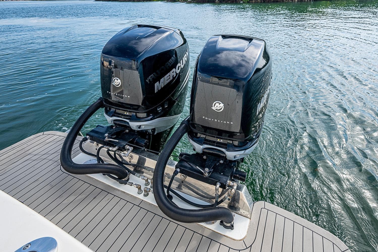 Twin Mercury outboard engines on a 2021 Scout 330 LXF boat, docked on water.
