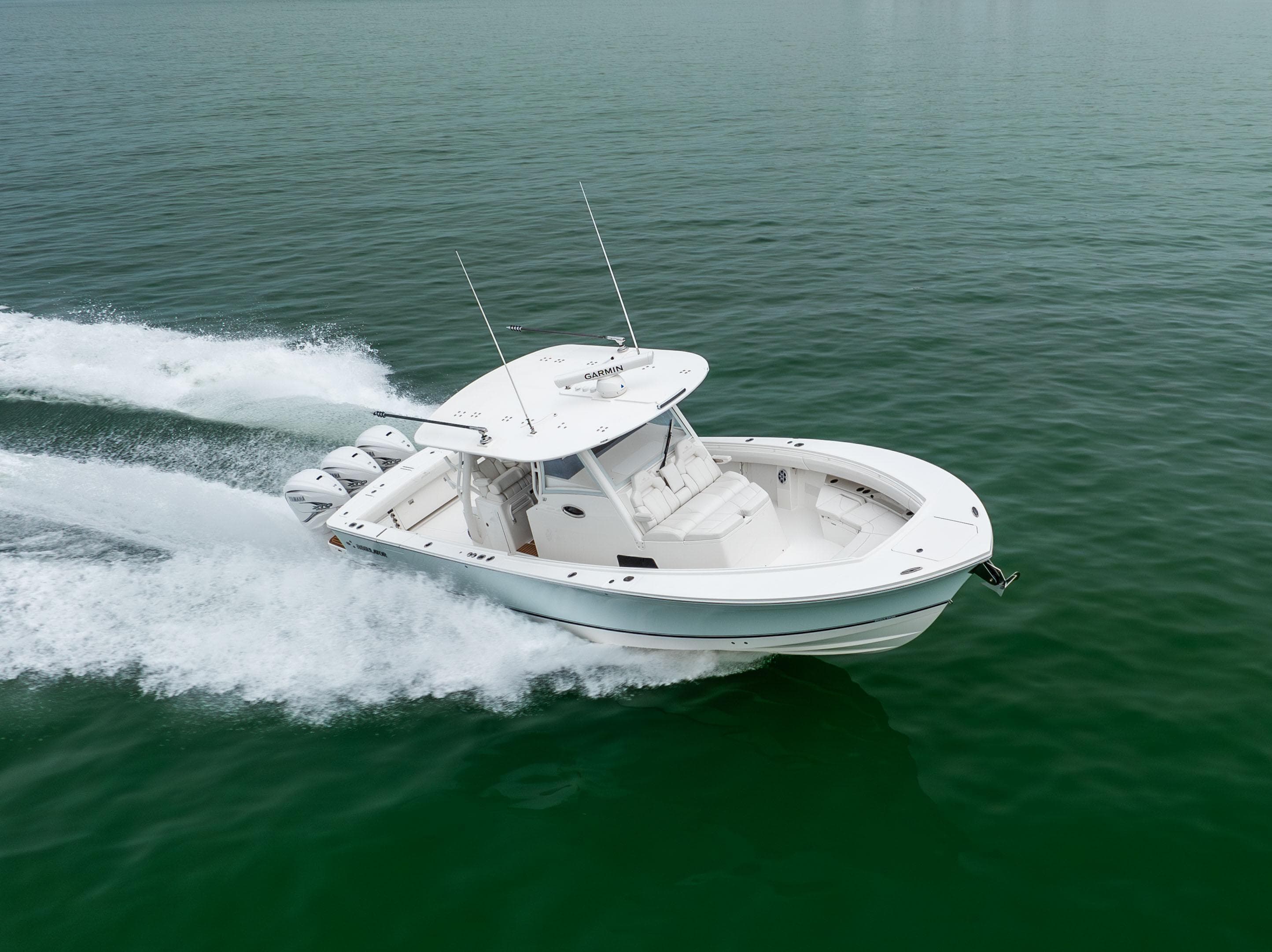 2023 Regulator 37 boat cruising on open water, showcasing sleek design and powerful engines.